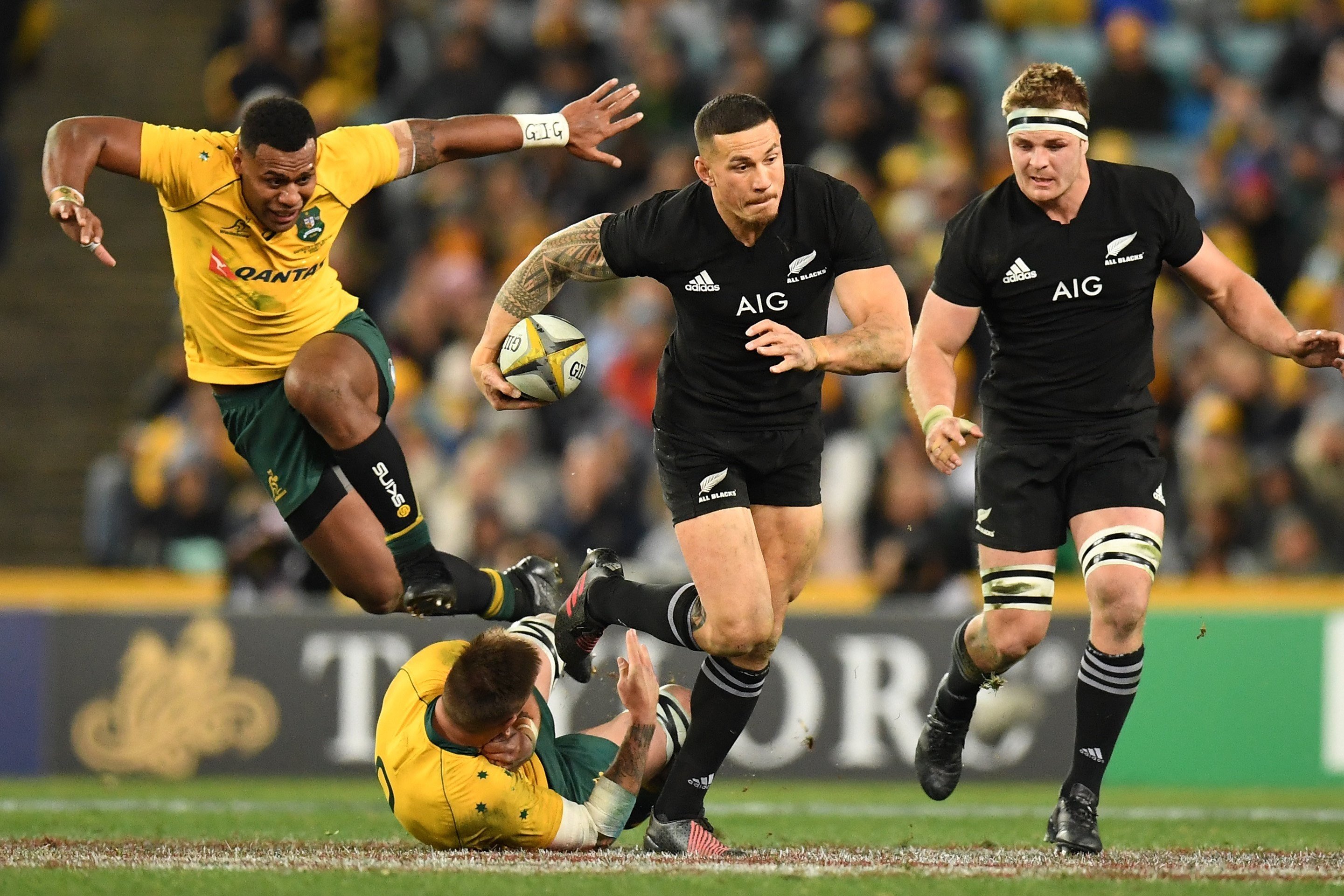 New Zealand’s Sonny Bill Williams steps through a tackle by Sean McMahon of Australia as Samu Kerevi of Australia leaps during game one of the Bledisloe Cup. Photos: EPA