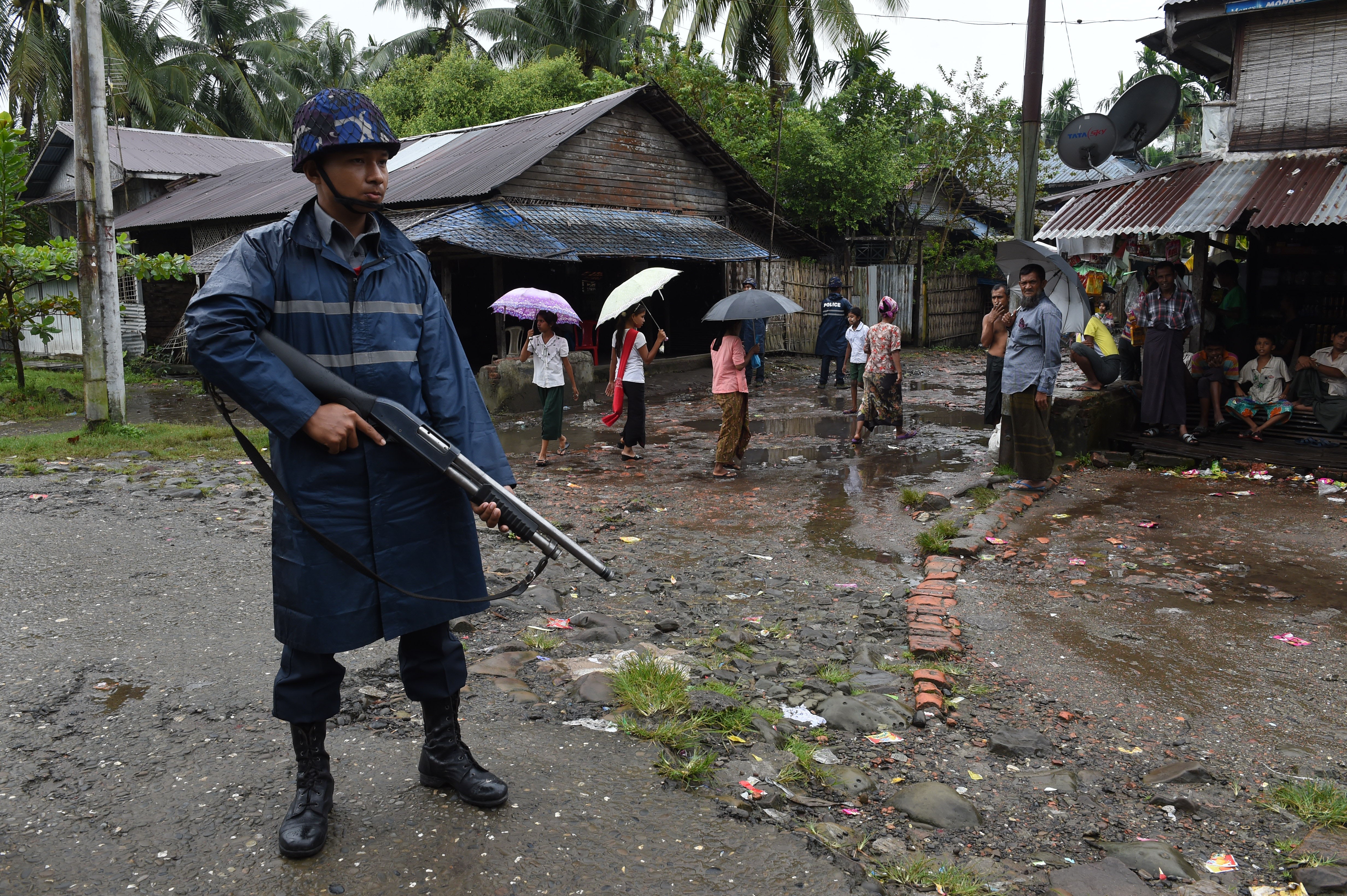 An armed policeman on guard at a displacement camp for the minority Muslim Rohingya in Myanmar’s Rakhine State. Picture: AFP