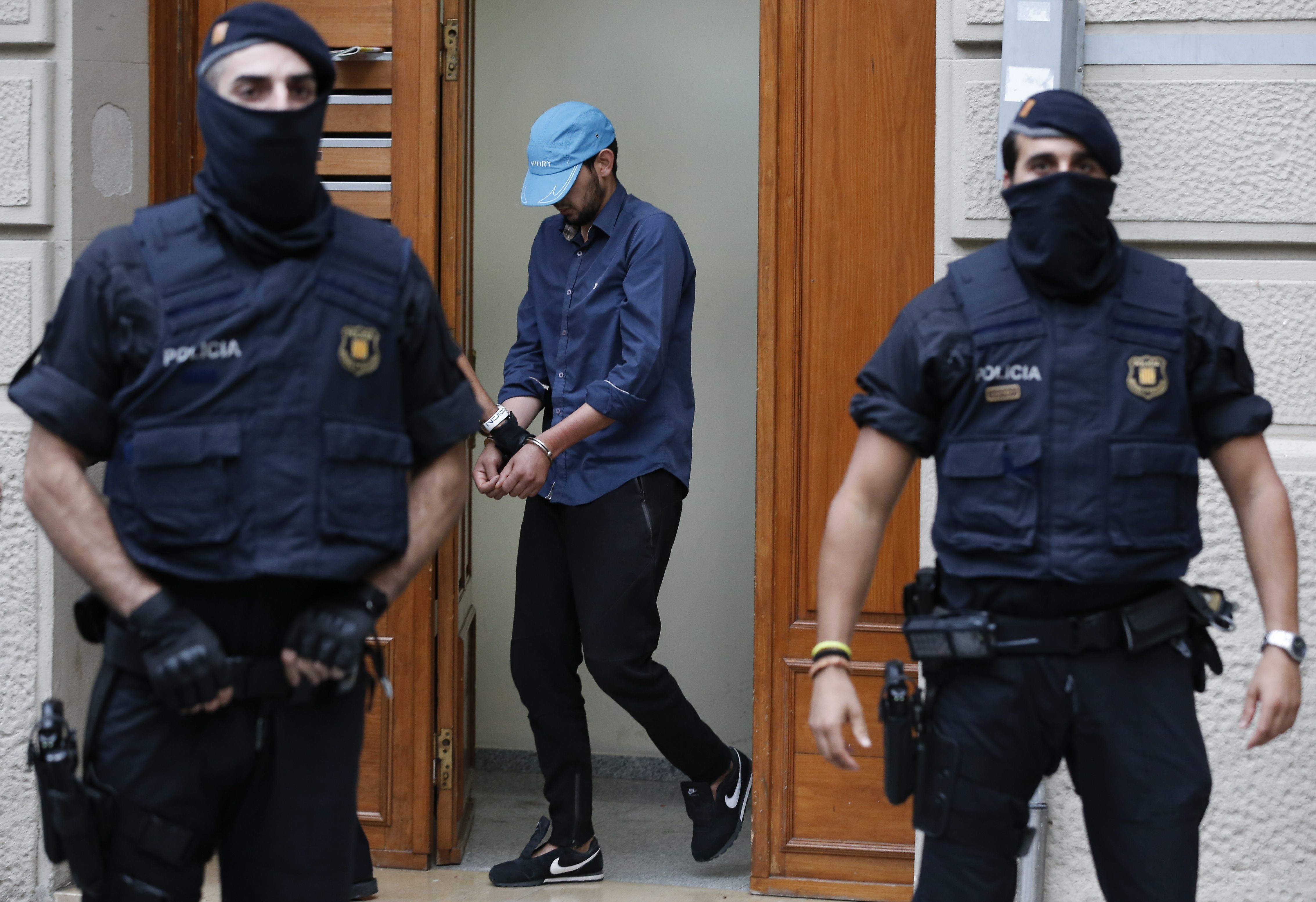 Catalan autonomous police officers detain a cuffed suspect in Ripoll during a search linked to the deadly terror attacks in Barcelona and the seaside resort of Cambrils on August 18. Photo: AFP