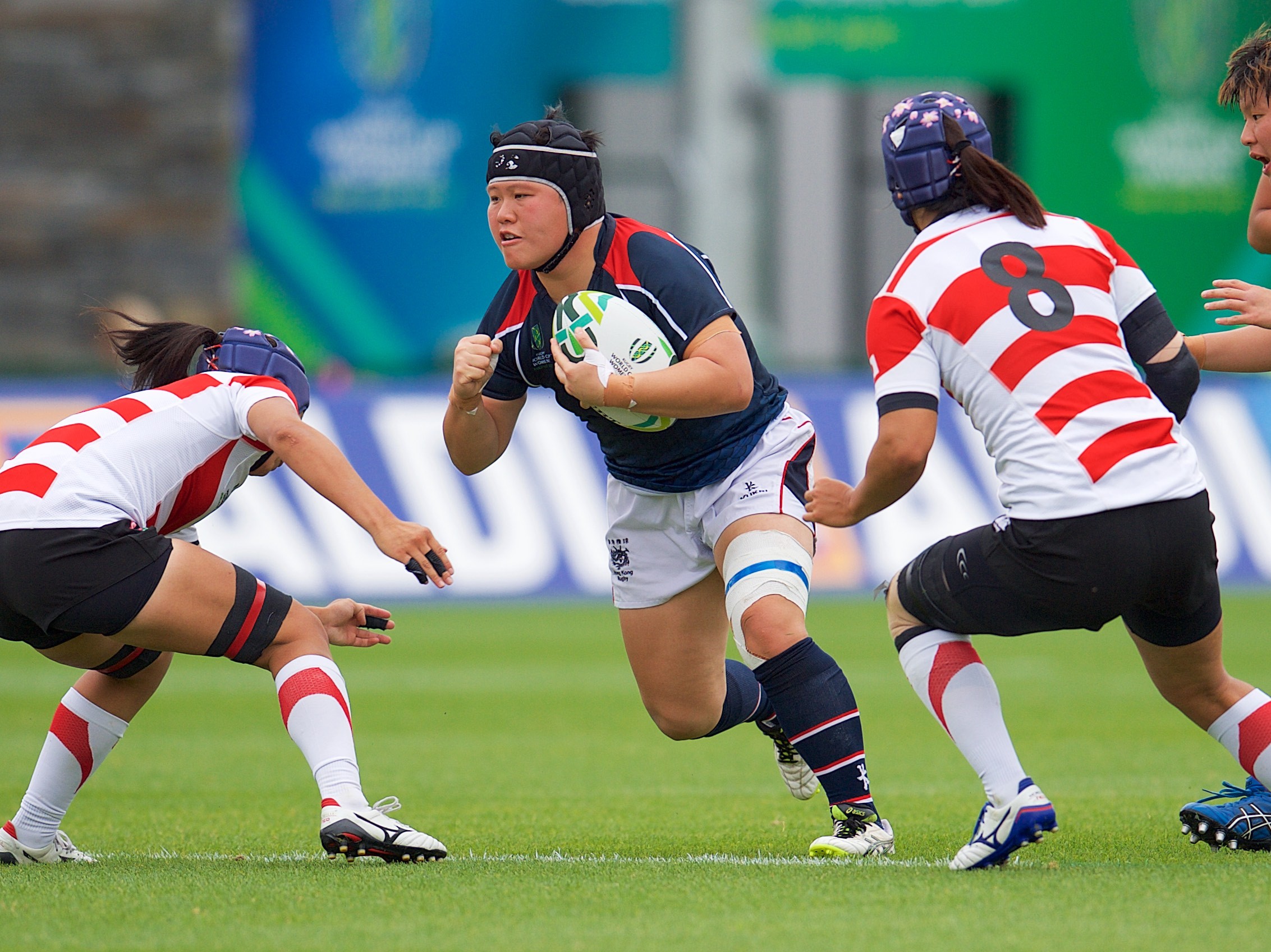 Hong Kong front rower Lee Ka-shun surges forward during her side’s 44-5 loss to Japan in Belfast. Photos: HKRU