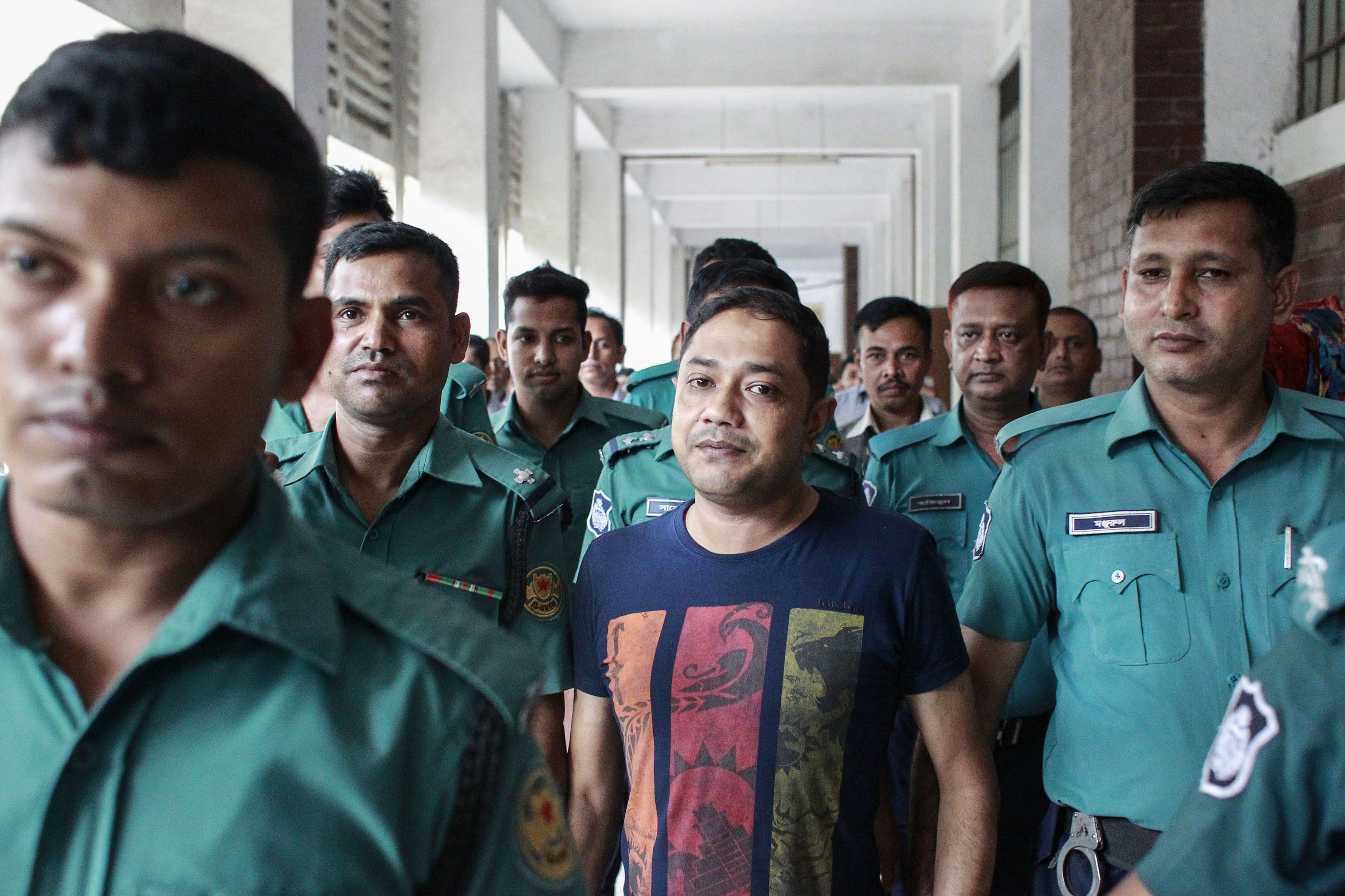 Bangladeshi security personnel escort Sohel Rana after a court appearance in Dhaka. Photo: AFP