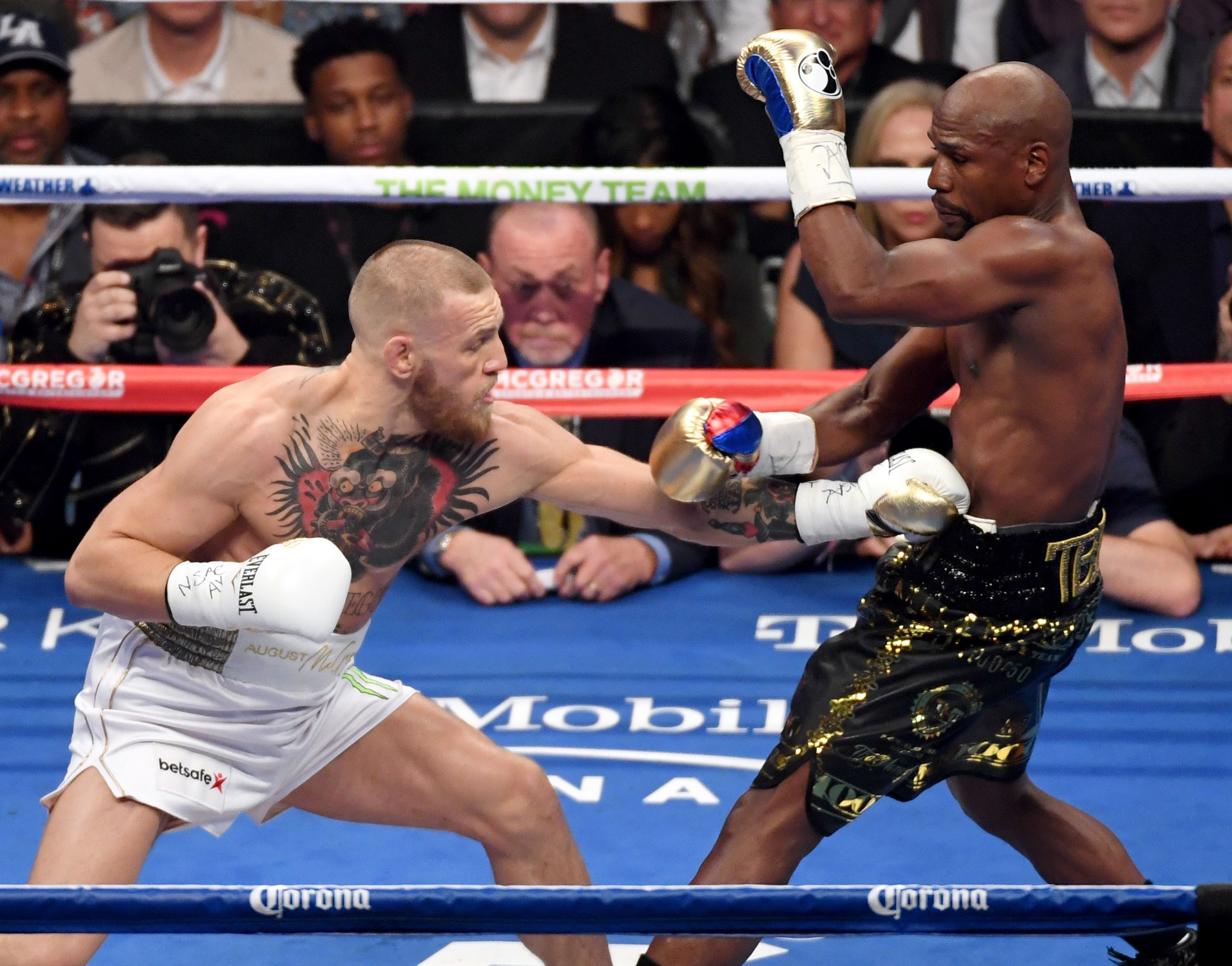 Floyd Mayweather Jnr (right) secured a 10th-round TKO victory against Conor McGregor. Photo: AFP