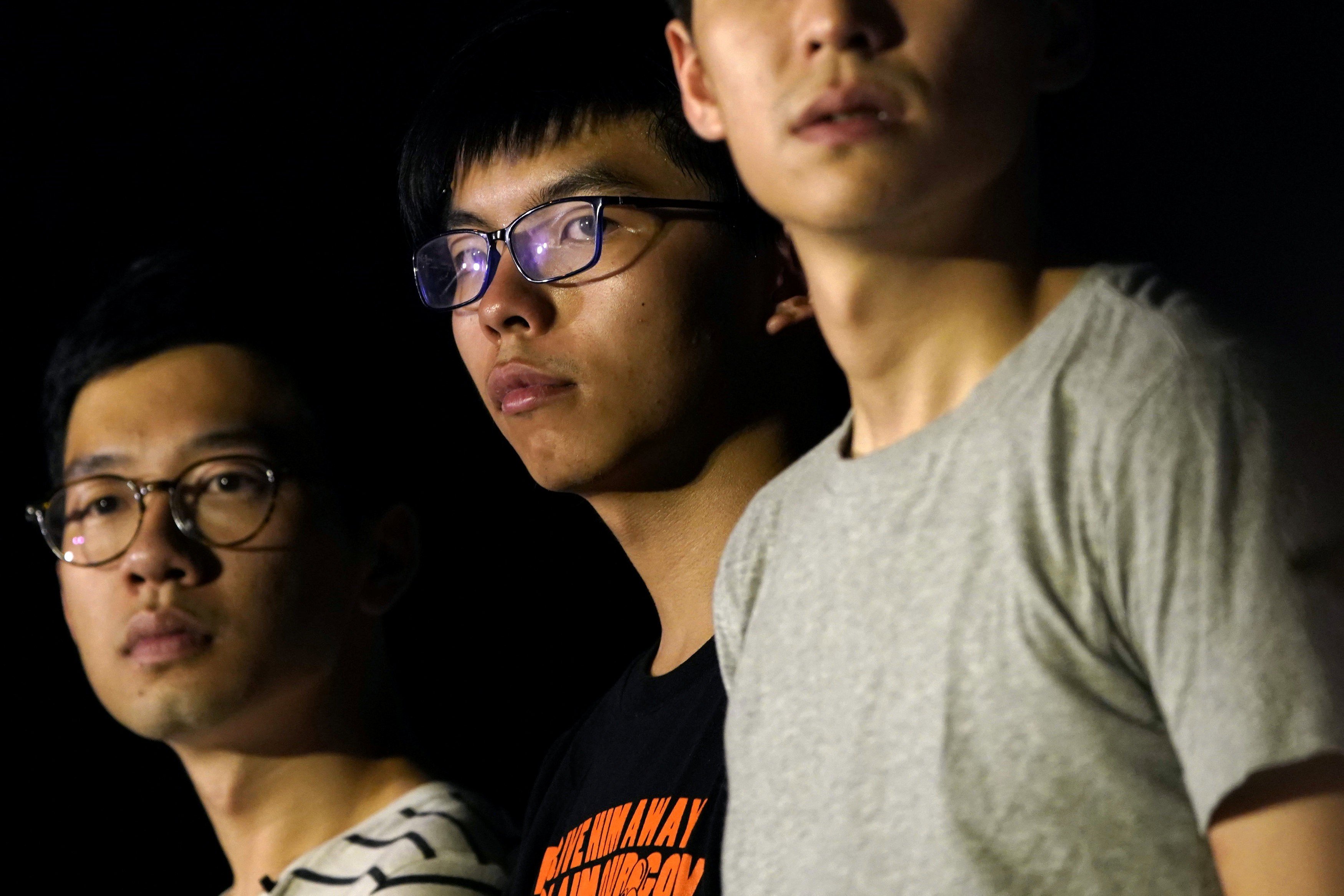 Nathan Law (left) and Joshua Wong (centre) attend a rally on August 16, a day before an appeals court jailed them, and a third student leader Alex Chow (not pictured), for their involvement in an Occupy-related protest in 2014. Photo: Reuters