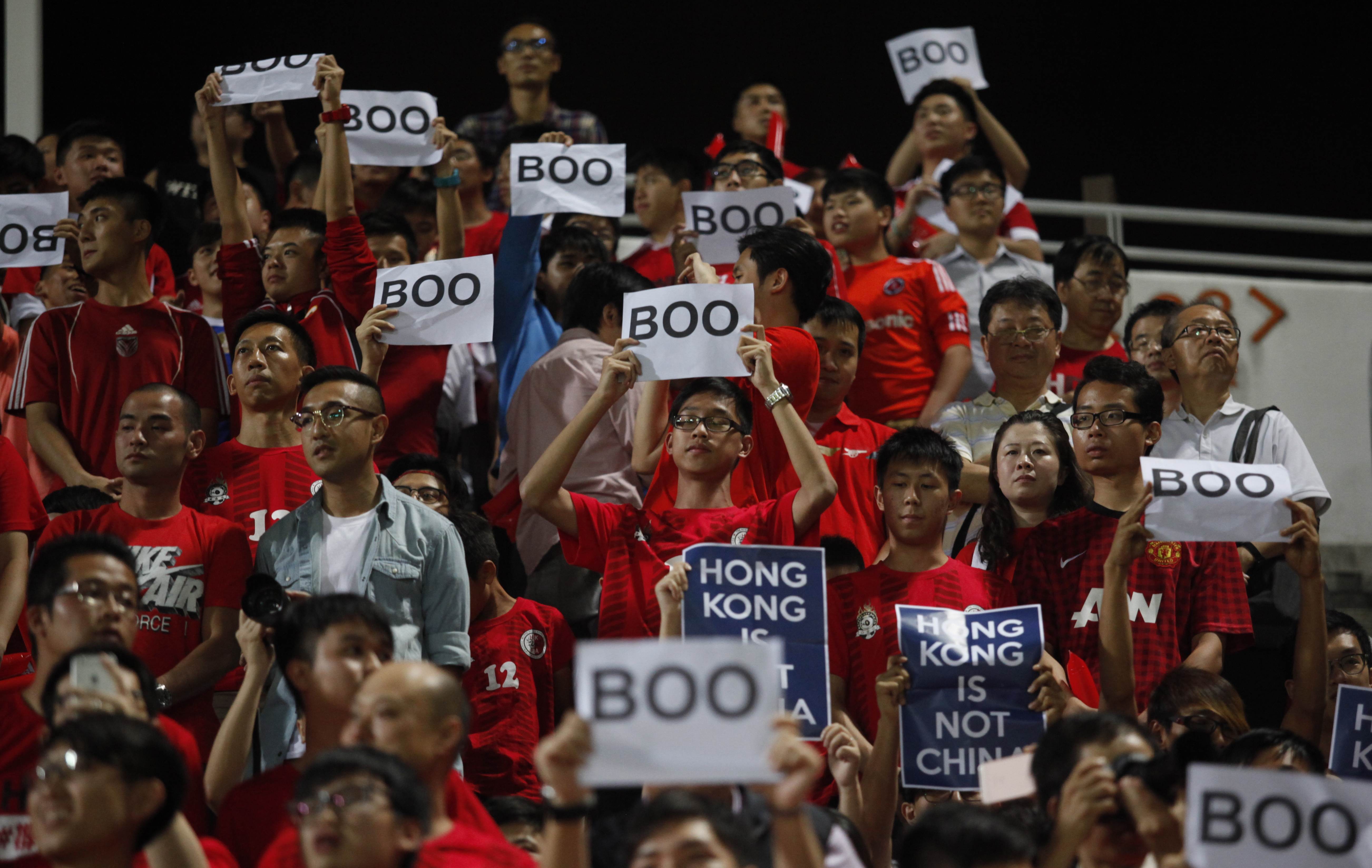 Hong Kong fans hold up signs that read “Boo” while the national anthem was being played back in 2015. More ‘creative’ responses to the new national anthem law are likely next October. Photo: AFP PHOTO