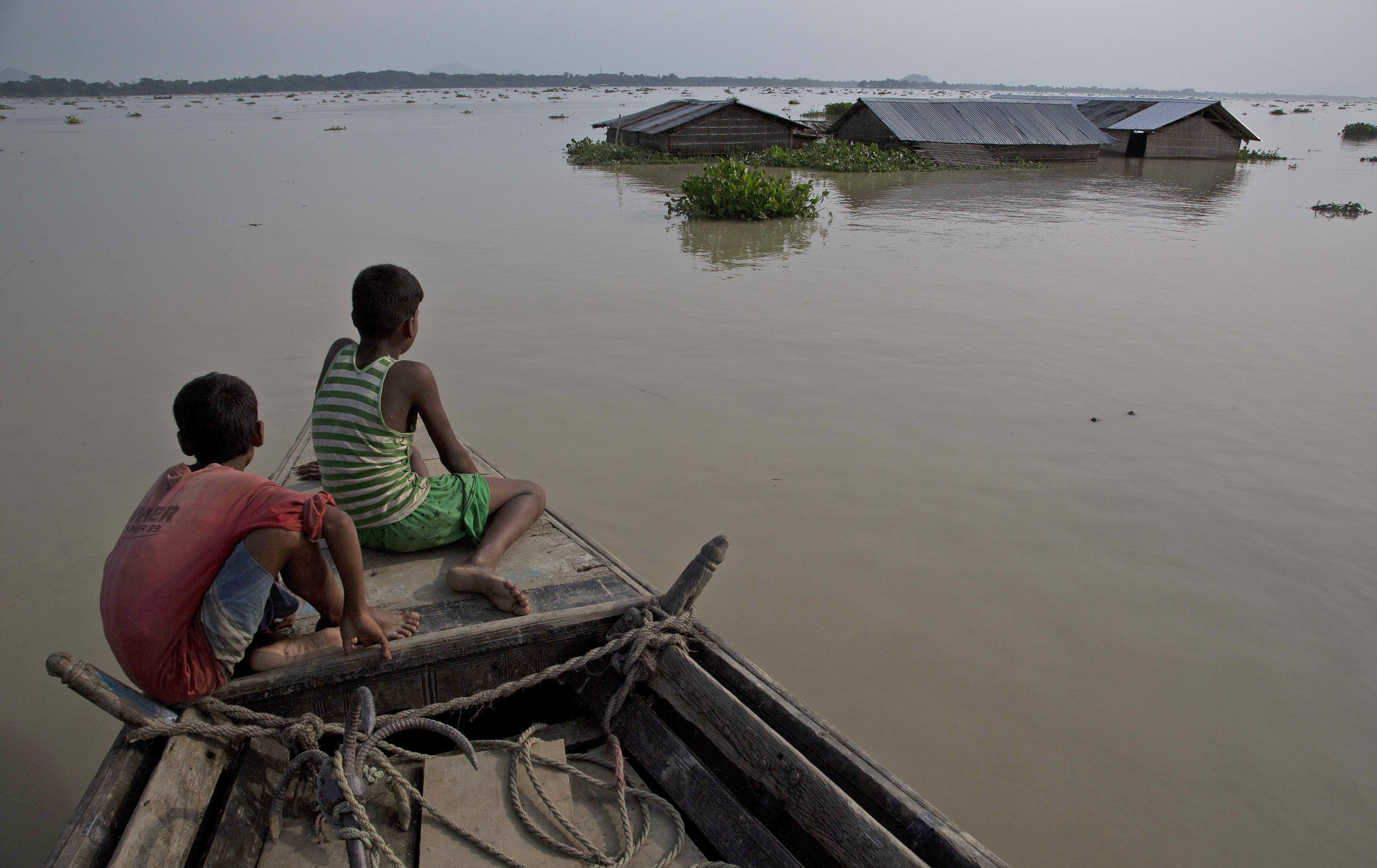 A boat offers refuge, with homes under floodwaters in Morigaon district, in the northeastern Indian state of Assam, on August 15. Heavy monsoon rains this year have unleashed landslides and floods, killing hundreds and displacing millions more across northern India, southern Nepal and Bangladesh. Photo: AP