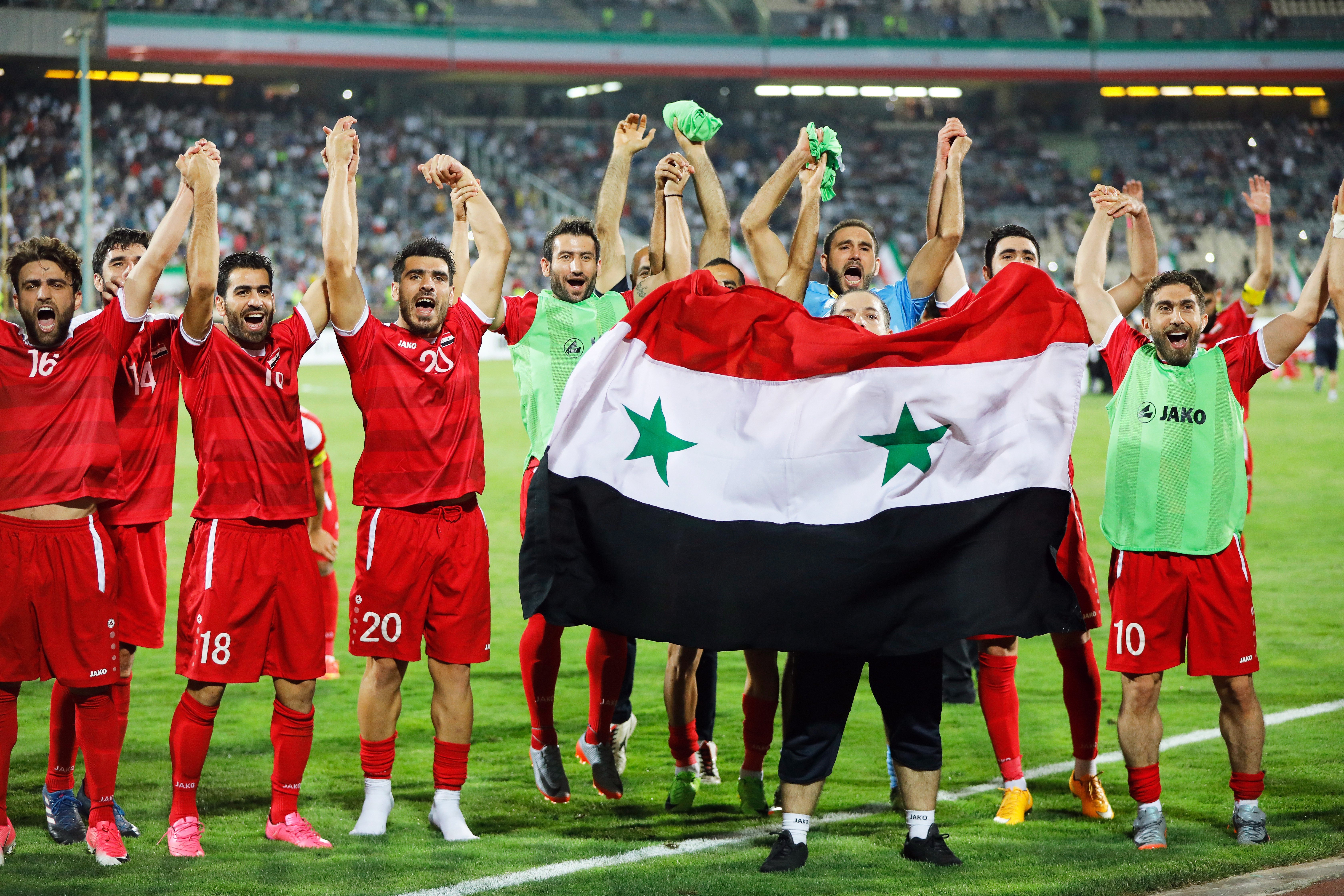Syria players celebrate after the Fifa World Cup 2018 qualifying draw against Iran put them into a qualification play-off. Photo: EPA