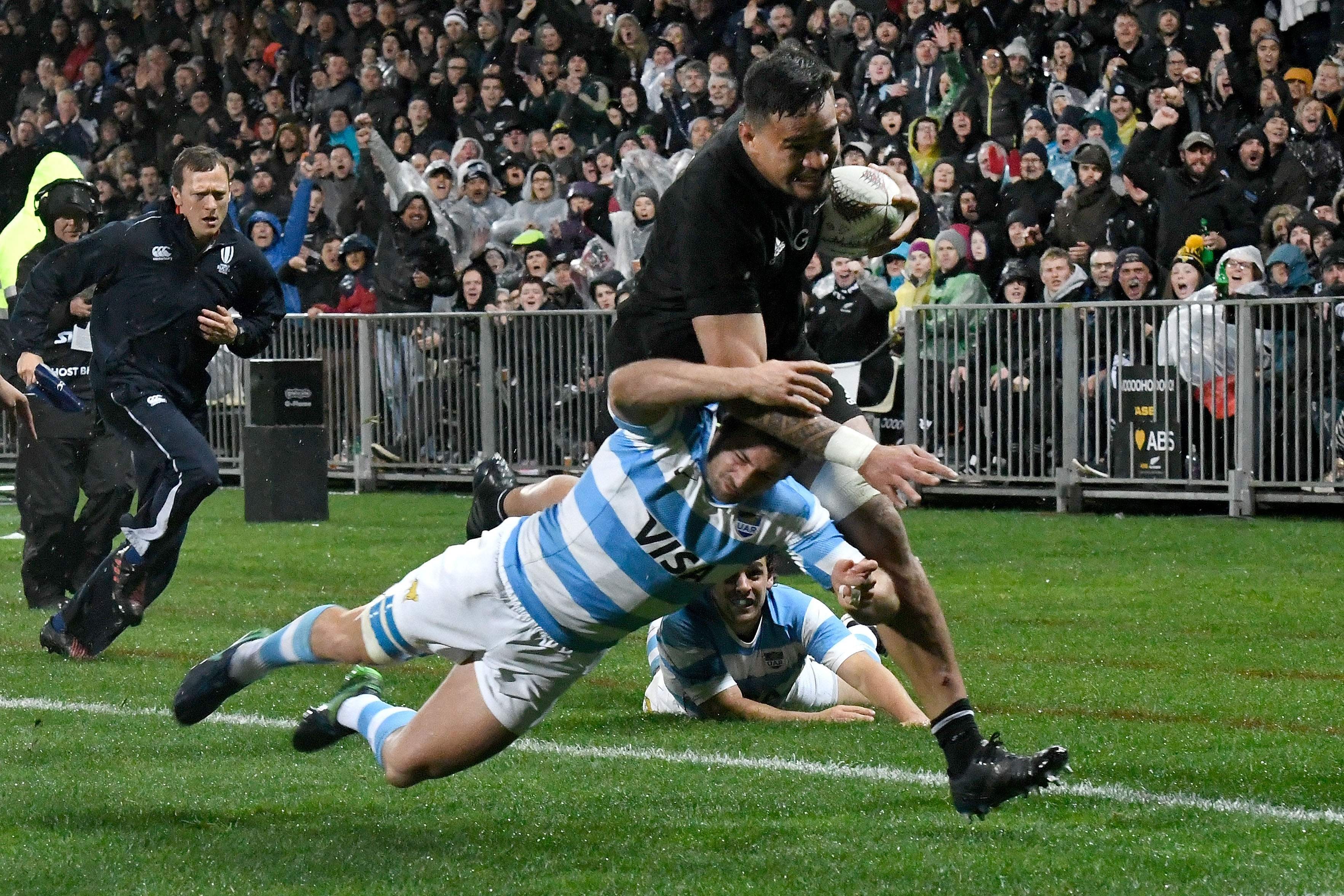 New Zealand’s Vaea Fifita (right) runs in a try as he is tackled by Argentina’s Santiago Cordero. Photo: AFP