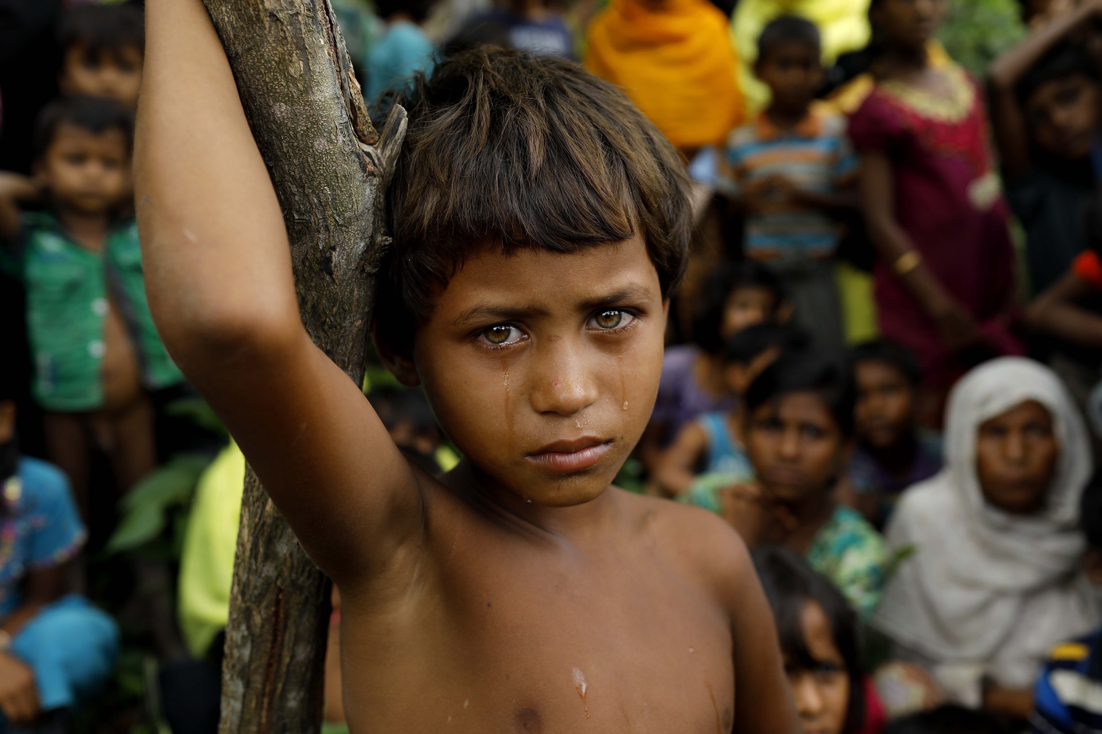 A tearful girl stands among other Rohingya refugees who arrived in Bangladesh on September 6 after fleeing from Myanmar. Photo: AFP