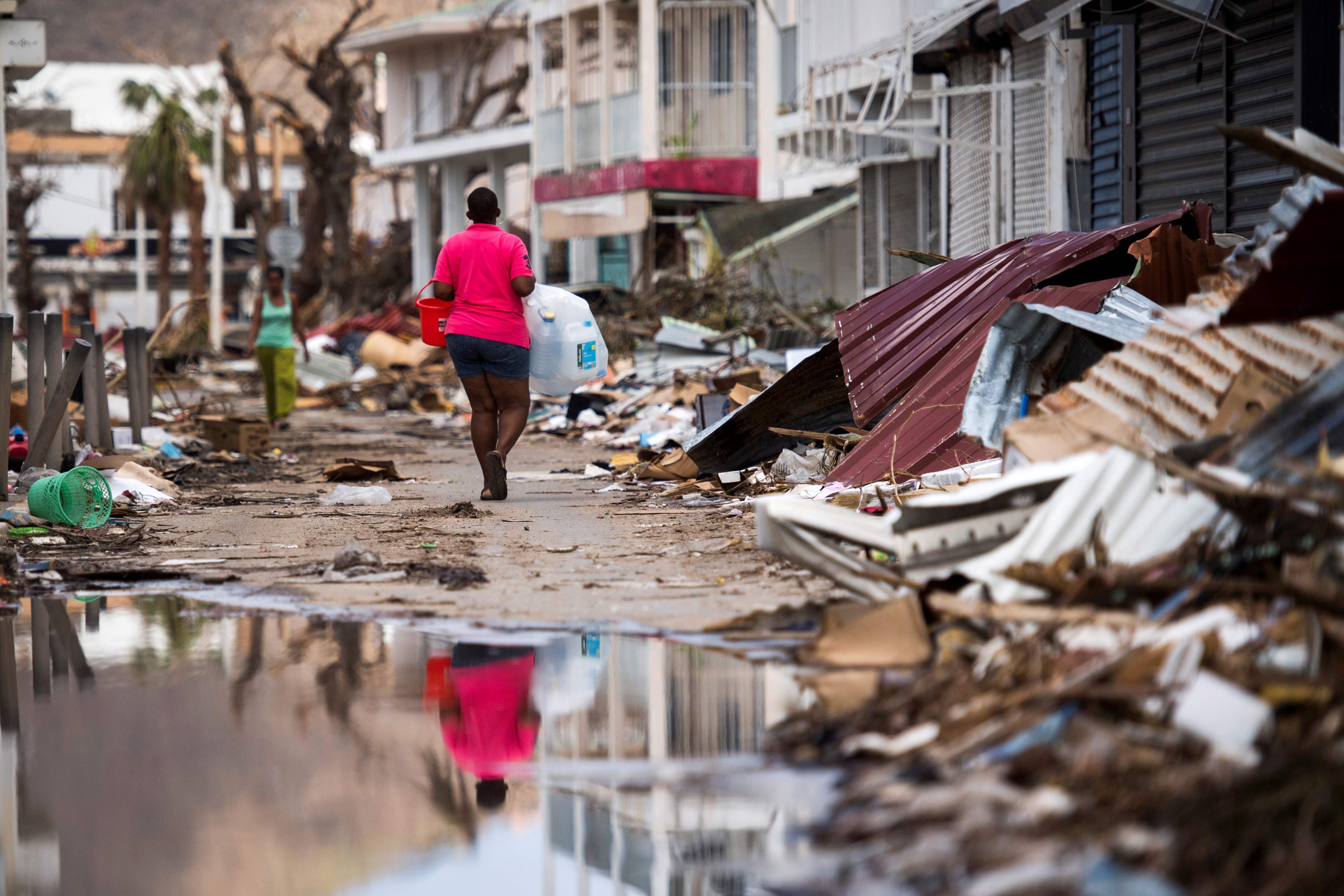 A woman walks down a street on the French Caribbean island of St Martin after it was hit by Hurricane Irma. Photo: AFP