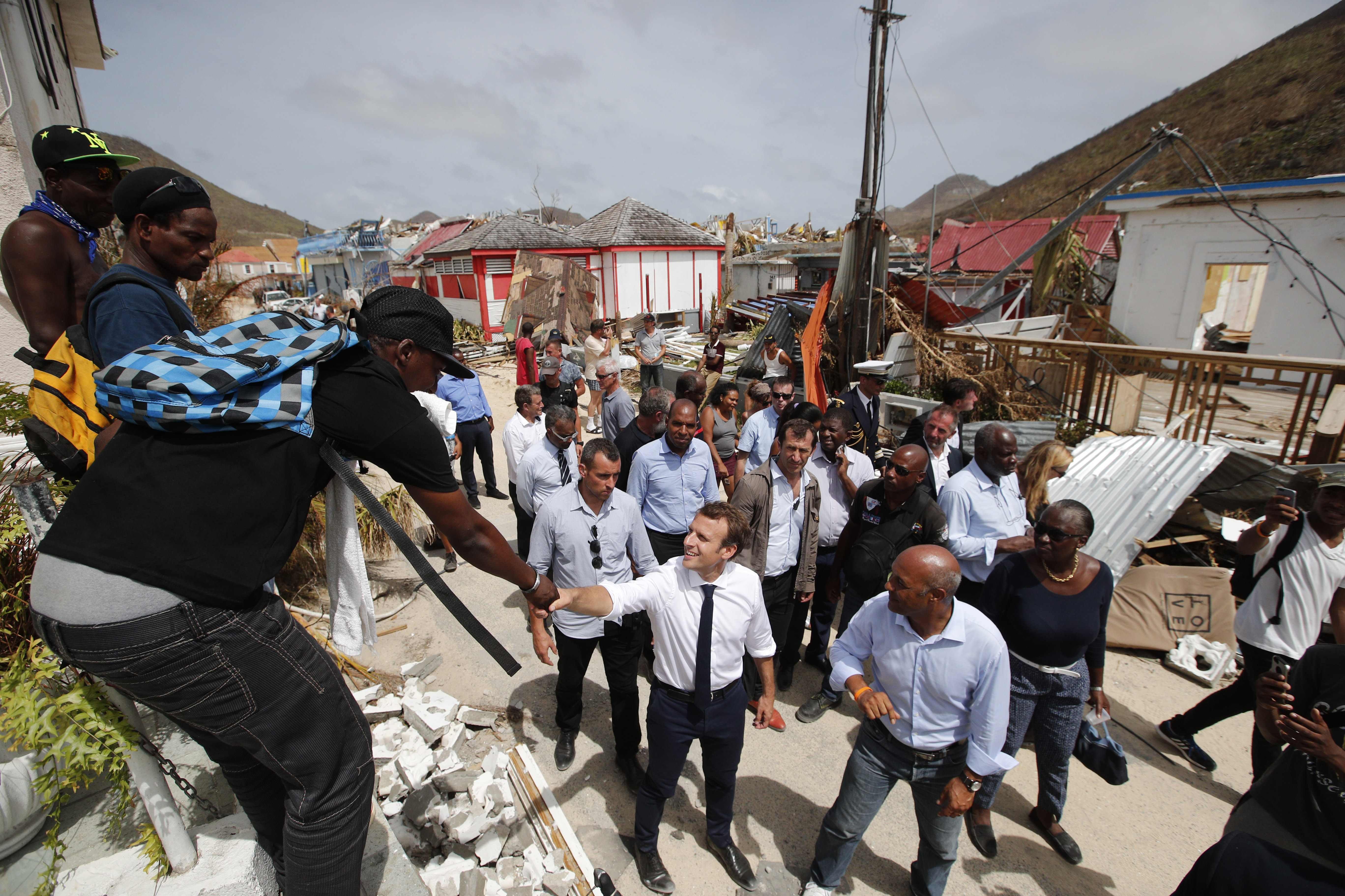 French President Emmanuel Macron (centre) shakes hands with residents during a visit to the French Caribbean island of St Martin on Tuesday. Photo: AFP