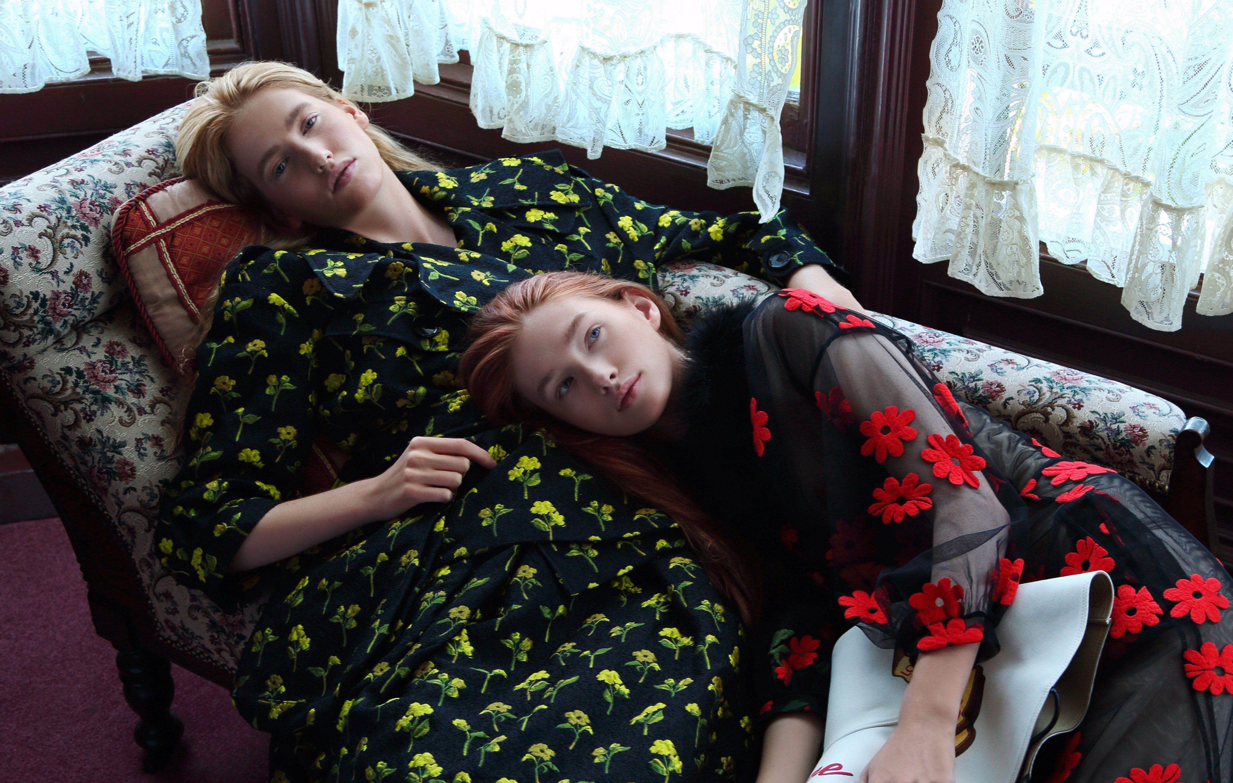 Olivia (left) wears black jacket with embroidered yellow flowers (US$2,560) and matching skirt (US$1,702), both by Simone Rocha from I.T. Sarah wears sheer dress with red embroidered flowers by Simone Rocha from I.T (inquiries: 2890 7012). Hat (US$666) by Loewe. Photography: Olivia Tsang