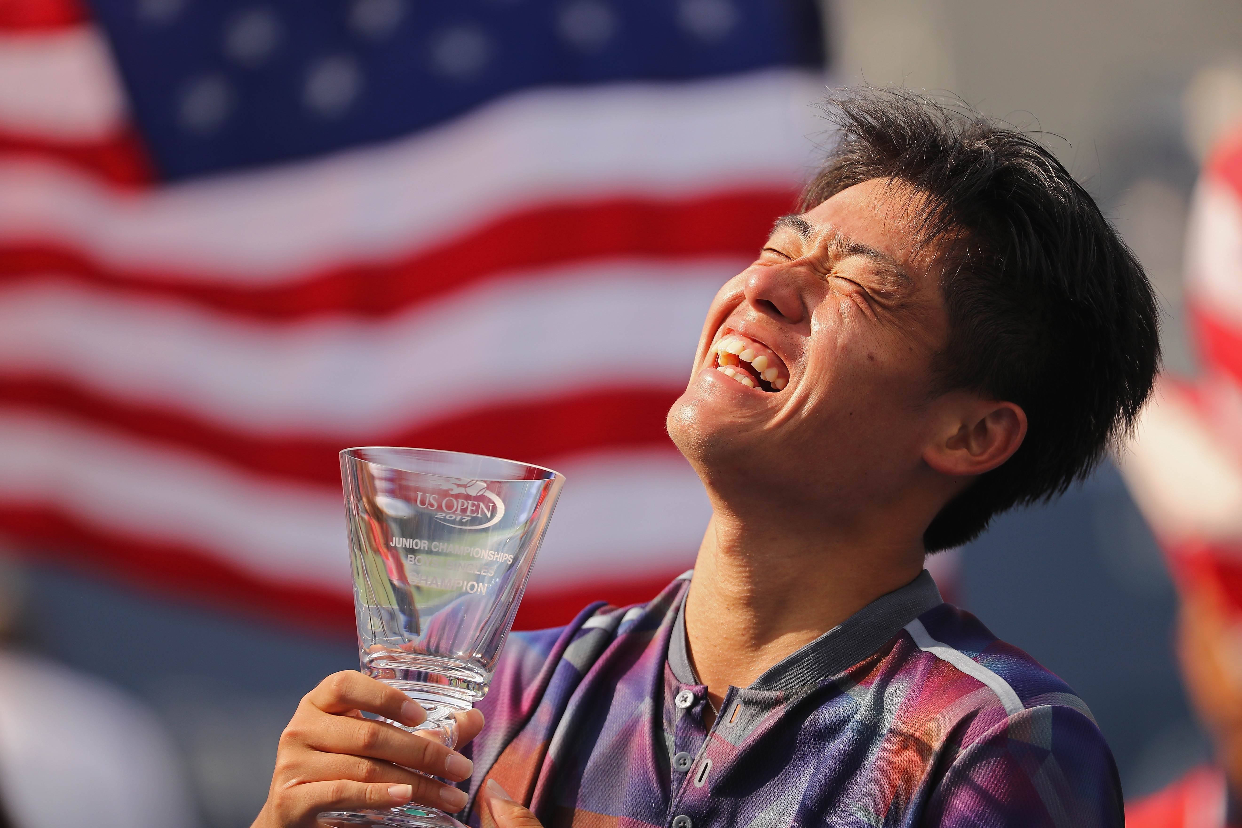 Wu Yibing with the championship trophy after defeating Axel Geller of Argentina in their Junior Boys' Singles final at the US Open. Photo: AFP