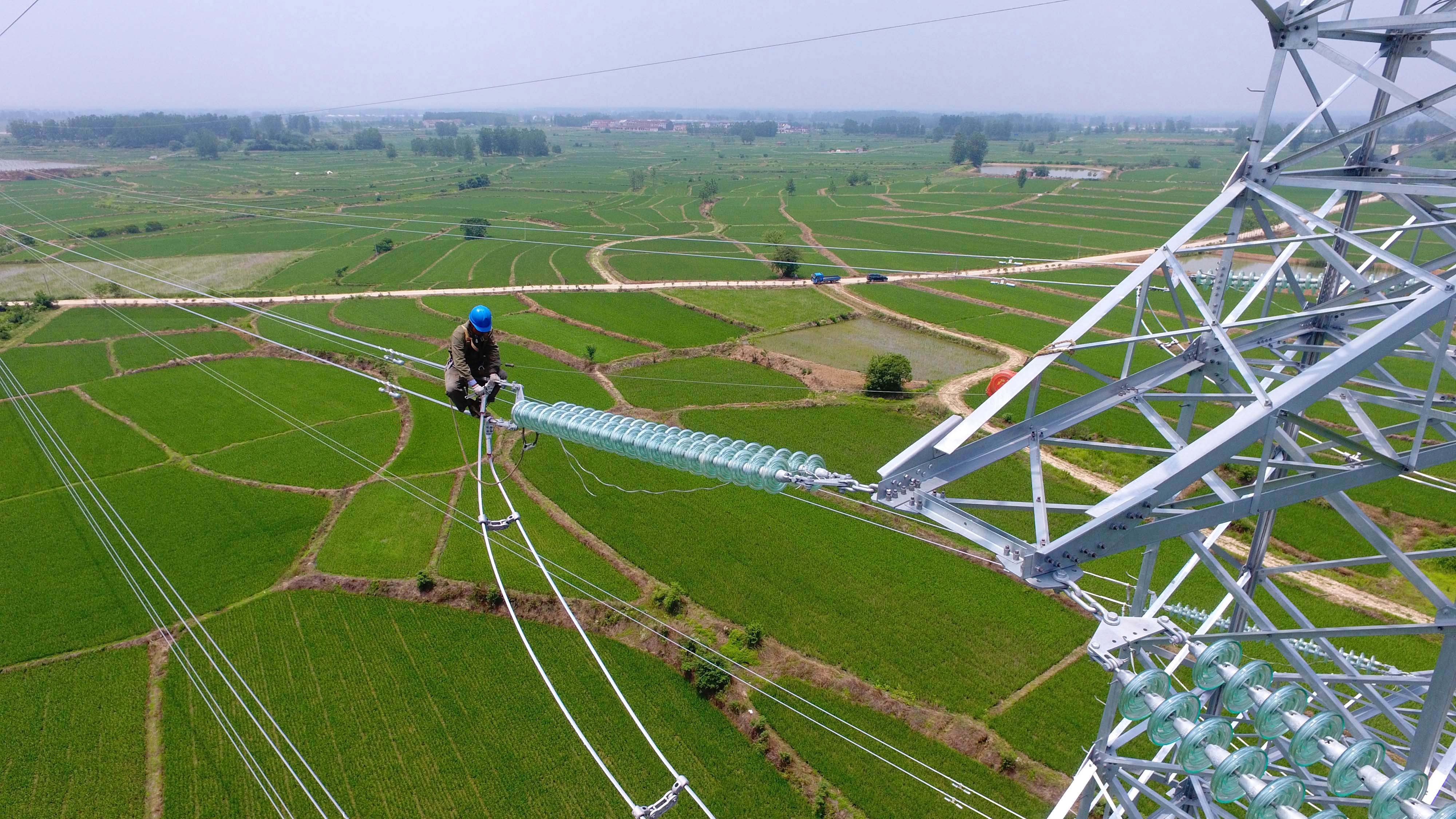A worker checks power lines during maintenance in Laian, Anhui province in July. Market-based principles are increasingly subordinated to long-term national strategic ambitions. Photo: AFP