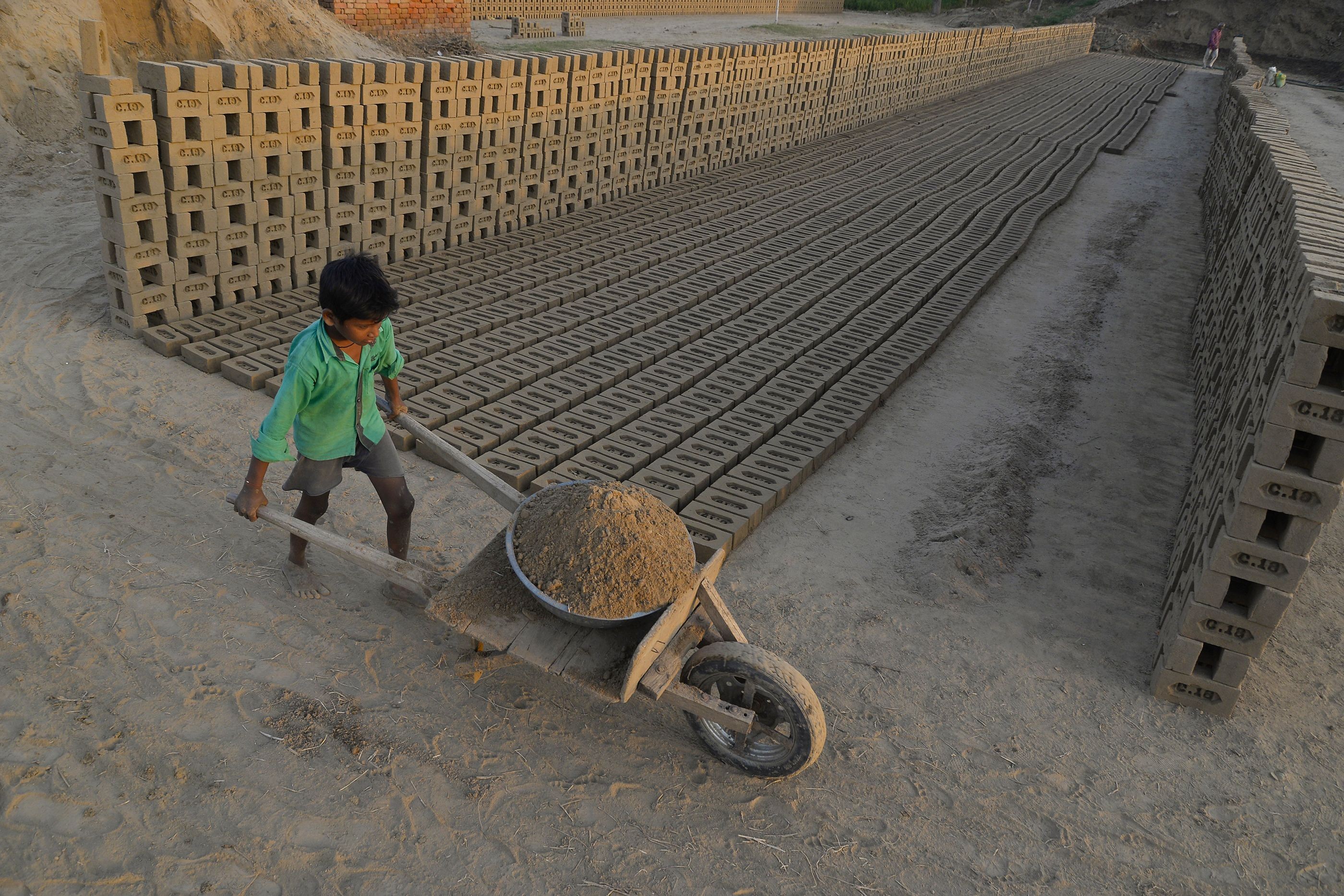 An Indian boy works in a brick kiln on the outskirts of Jalandhar on September 18. Many brick kiln workers in India are trapped in a cycle of bonded labour and regularly cheated out of promised wages, according to anti-slavery groups. Photo: AFP