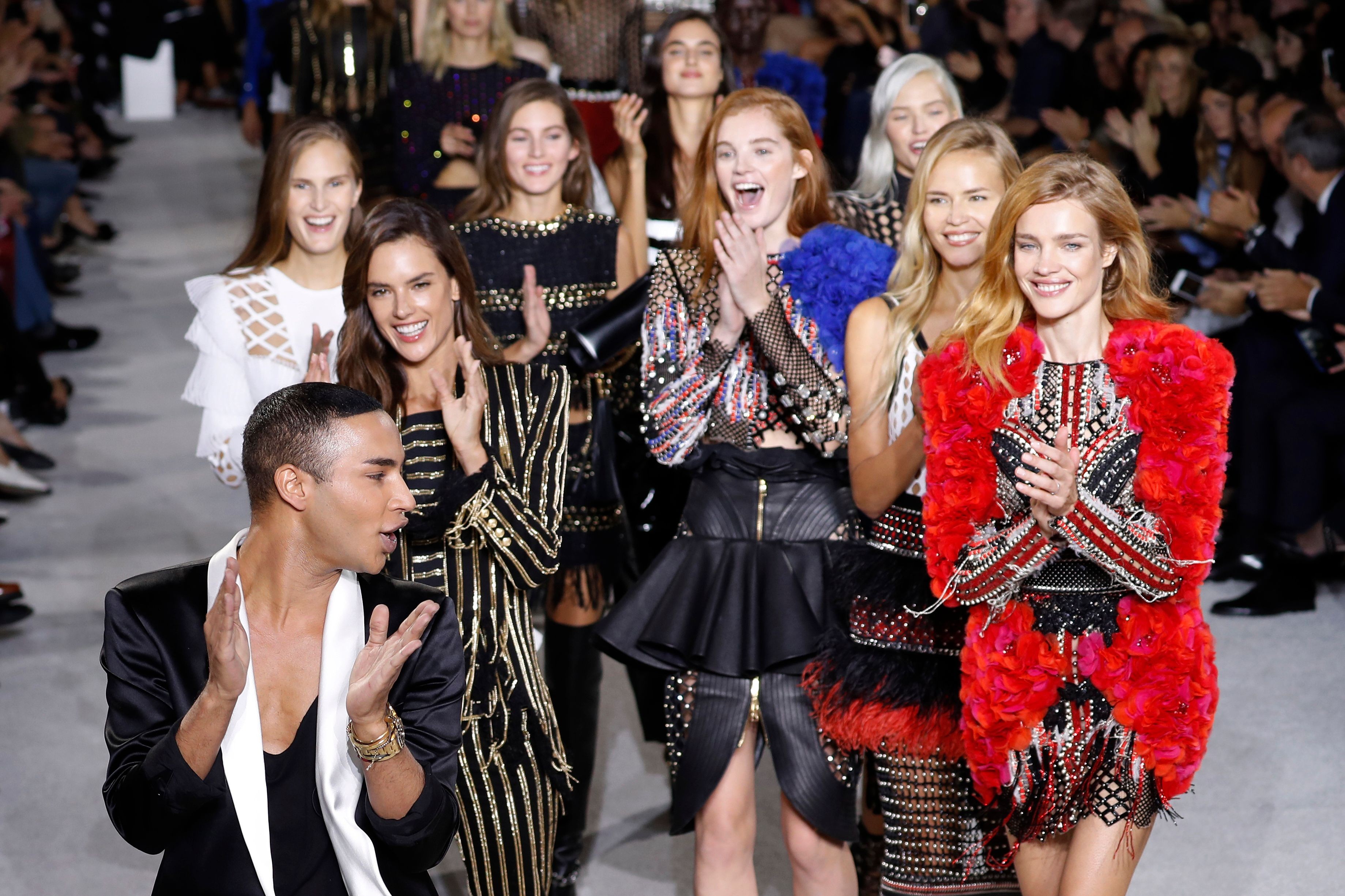 Models Alessandra Ambrosio, Natalia Vodianova, Natasha Poly present creations as Olivier Rousteing acknowledges the audience at the end of Balmain women's 2018 spring/summer ready-to-wear collection fashion show in Paris. Photo: AFP
