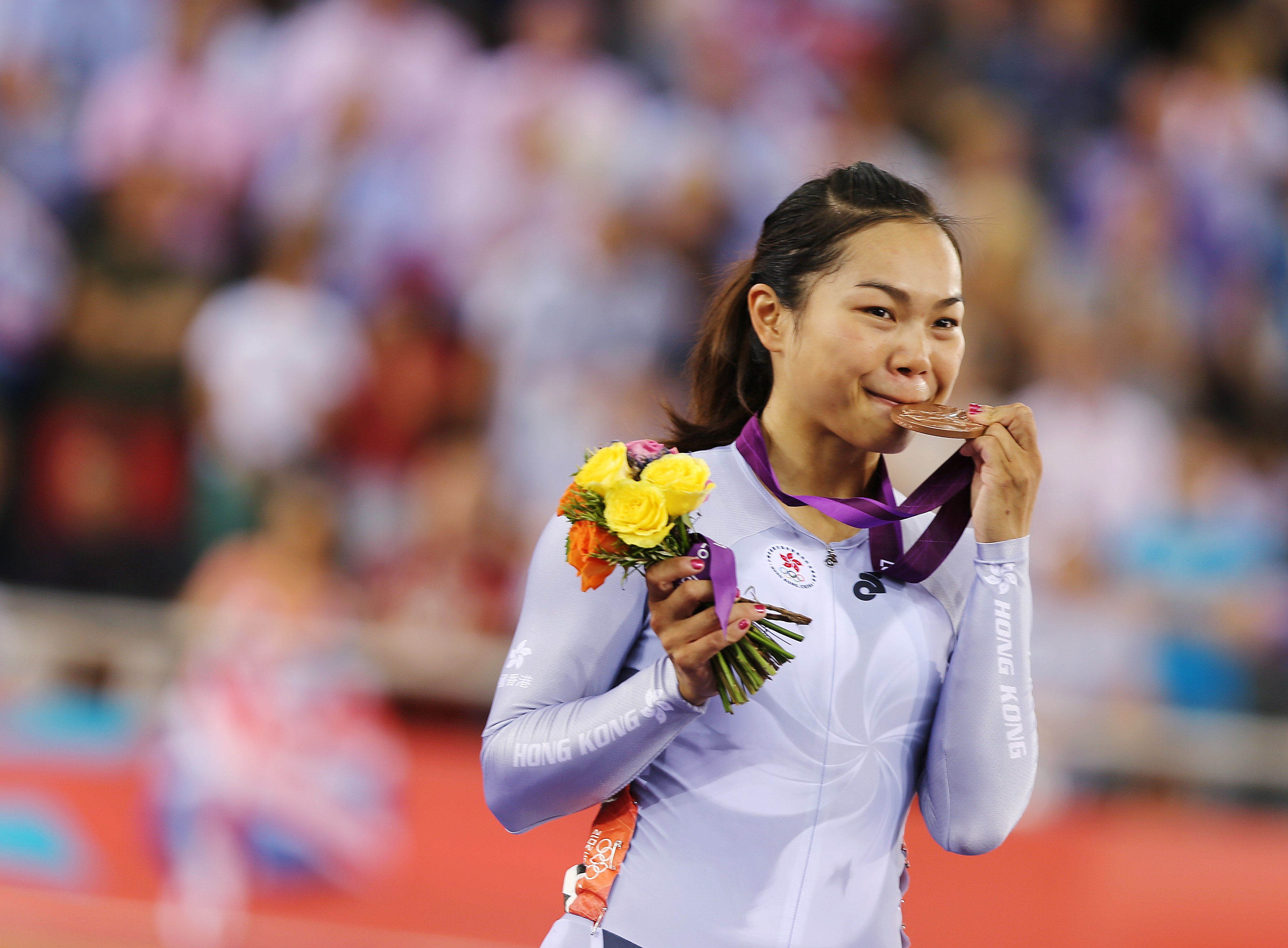 Lee Wai-sze bites her bronze medal at the London Olympics in 2012. Photo: SCMP