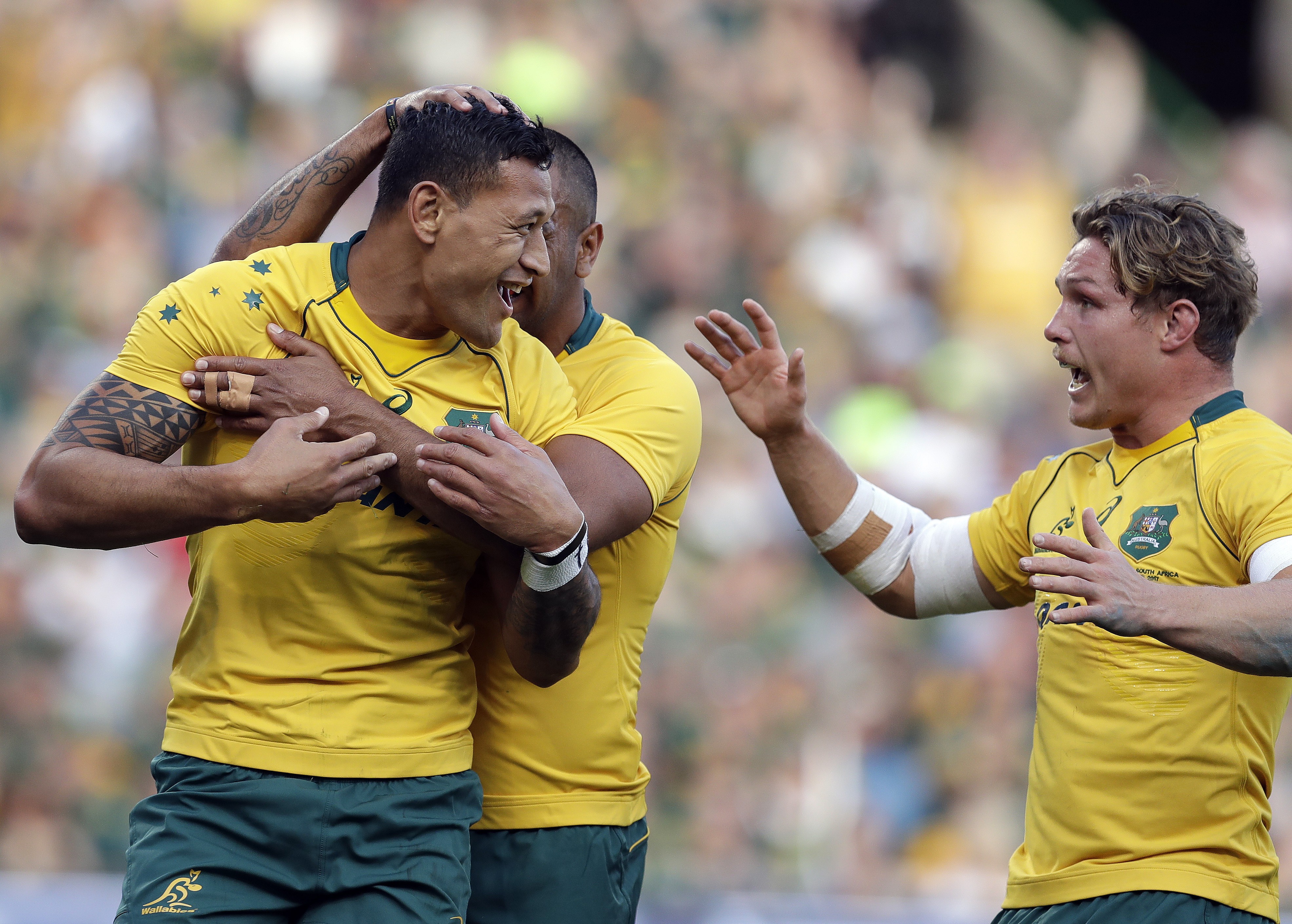 Australia’s Israel Folau is congratulated by teammates after scoring against South Africa in Bloemfontein. Photo: AP