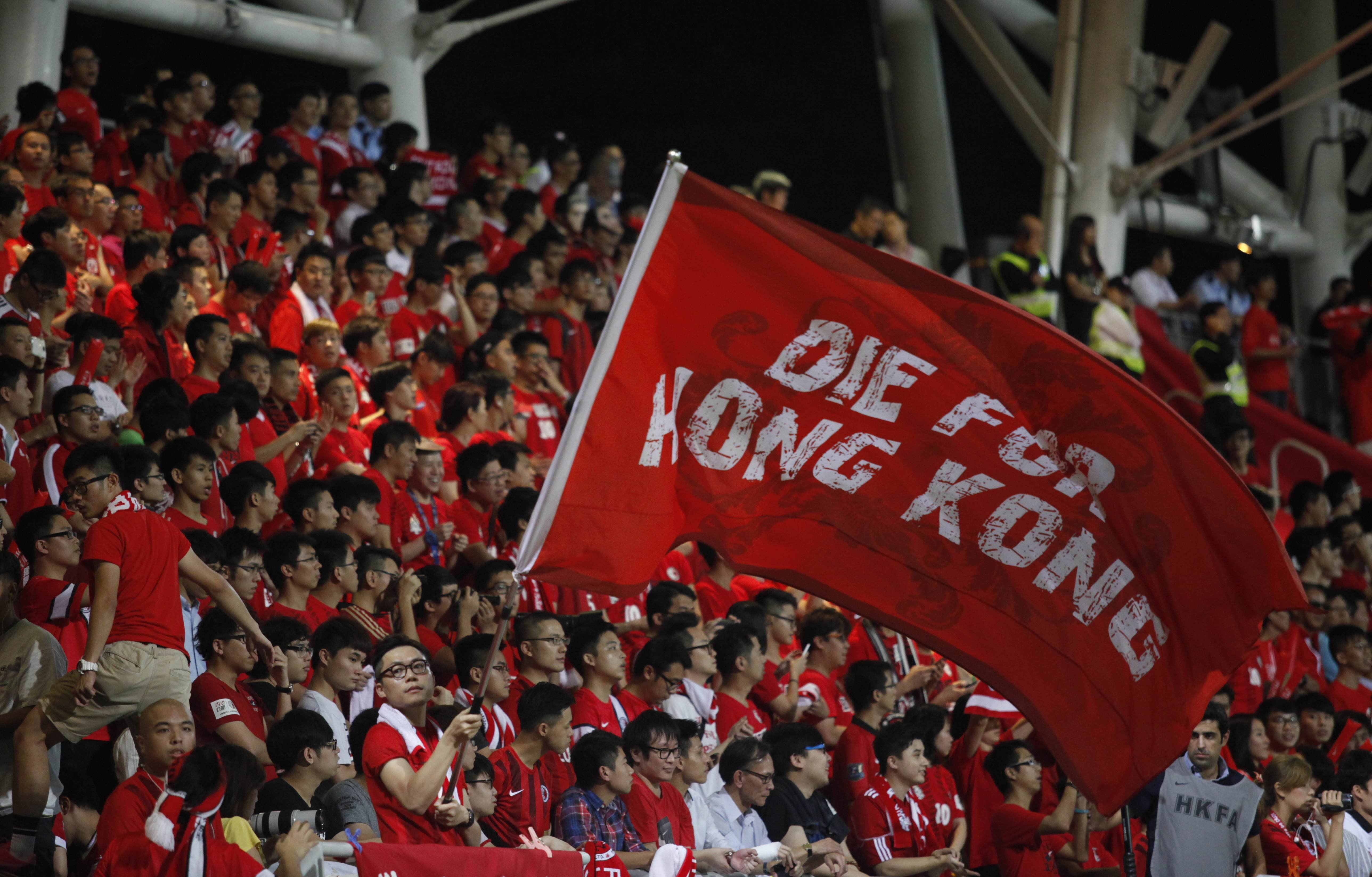 A Hong Kong Fan waves a flag at Mong Kok Stadium, scene of regular booing of the China national anthem.. Photo: AFP