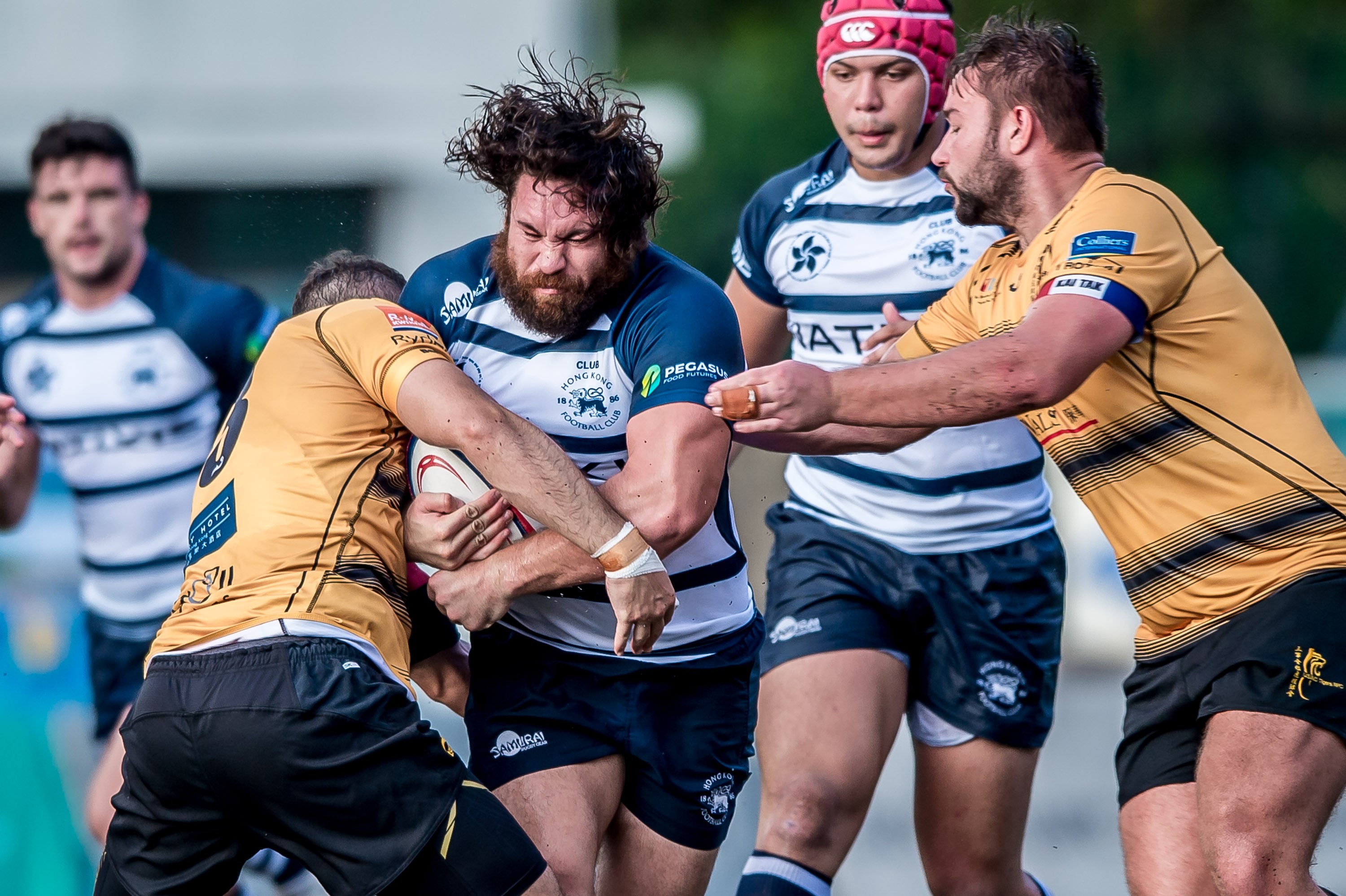 HKFC captain Mitch Andrews feels the brunt of the Tigers’ defence in his side’s 20-15 win in the Hong Kong Premiership. Photo: HKRU