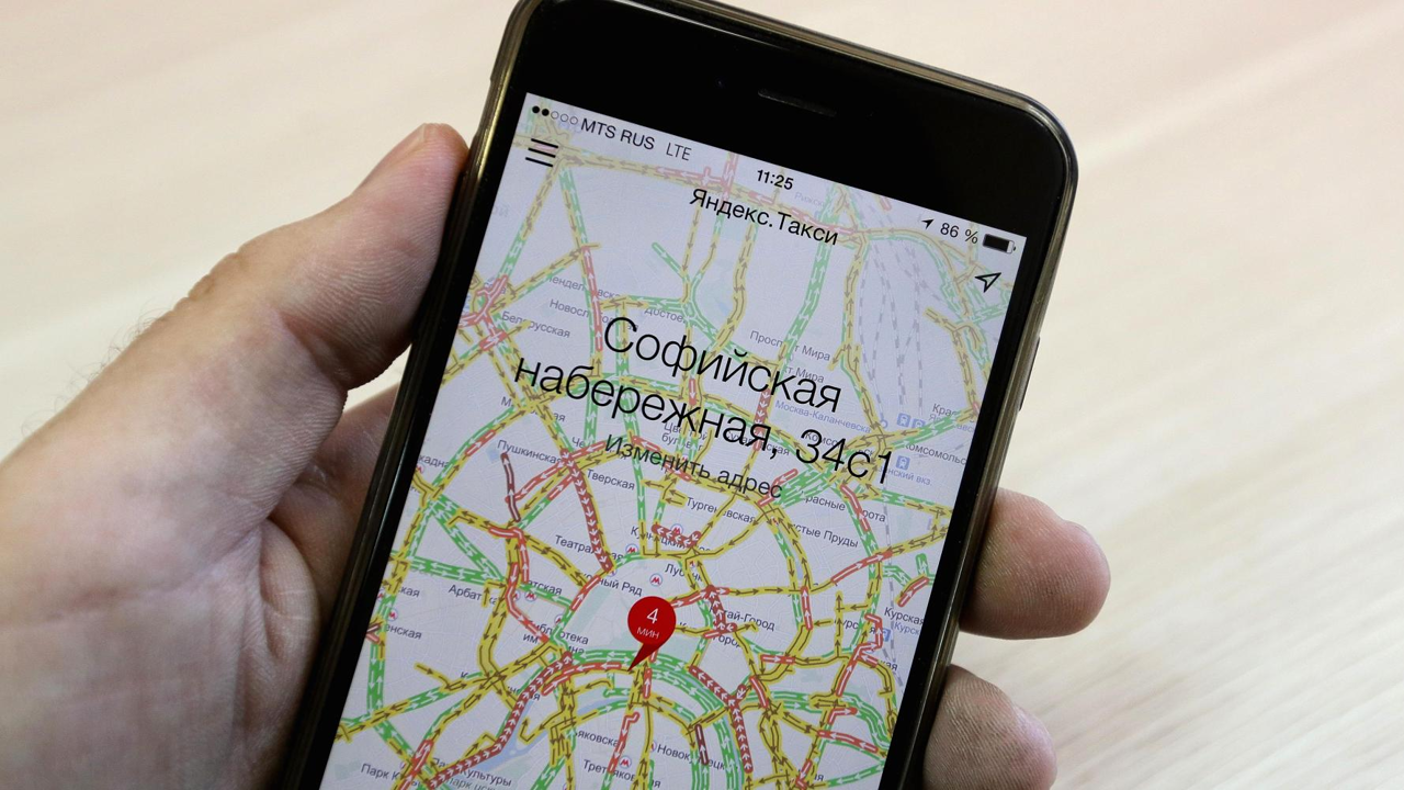 A customer uses the Yandex.Taxi online app on a smartphone to scan for available taxi cabs in Moscow, Russia. Photo: Andrey Rudakov/Bloomberg