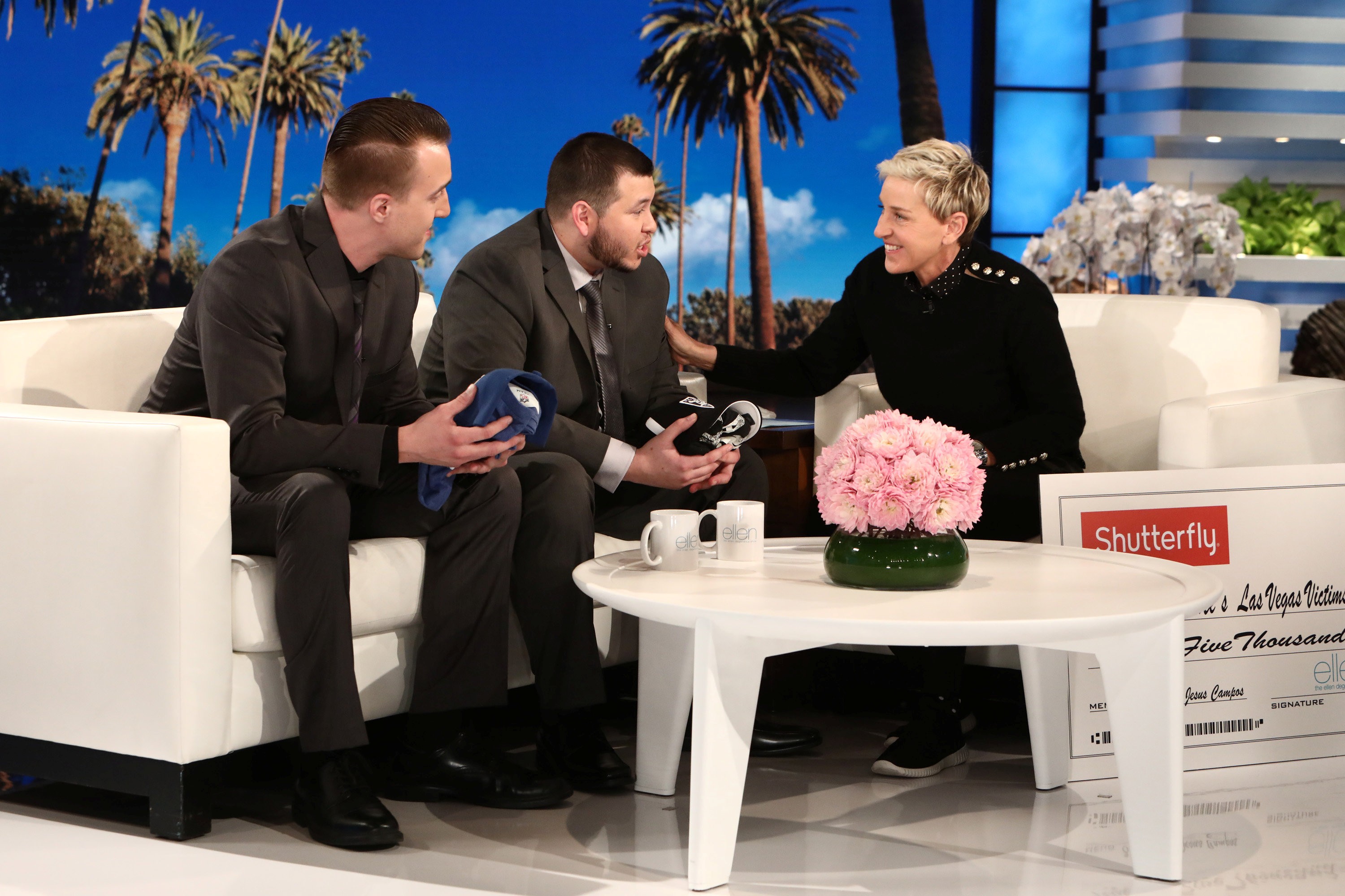 Stephen Schuck (left) and security guard Jesus Campos of the Mandalay Bay Resort and Casino in Las Vegas, are interviewed by host Ellen DeGeneres in this photo released Wednesday. Photo: Reuters