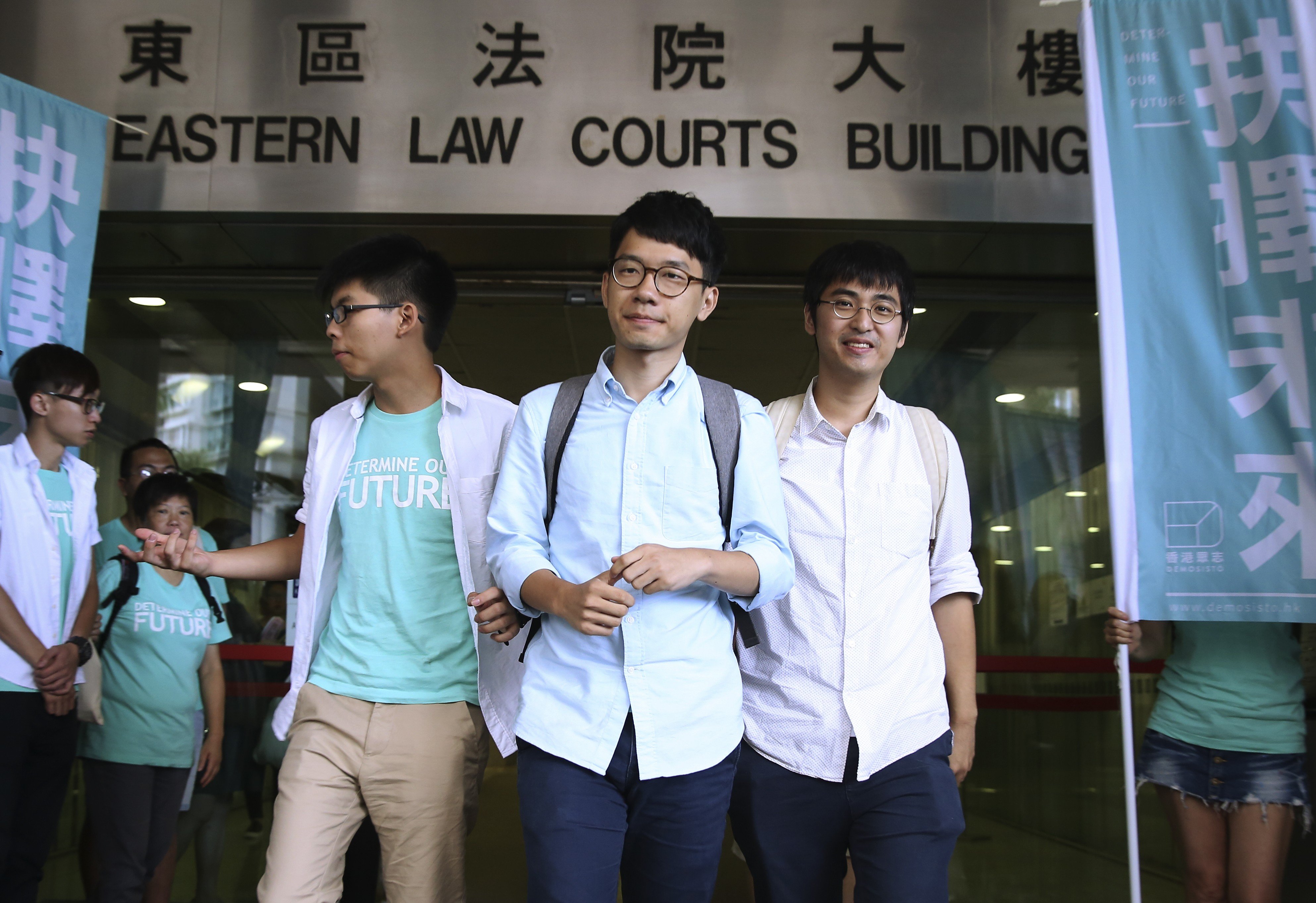 Occupy Central student leaders Joshua Wong Chi-fung, Nathan Law Kwun-chung and Alex Chow Yong-kang, seen here outside the magistrates’ courts in July last year, were convicted by a magistrate and originally given non-custodial sentences. Photo: Sam Tsang.