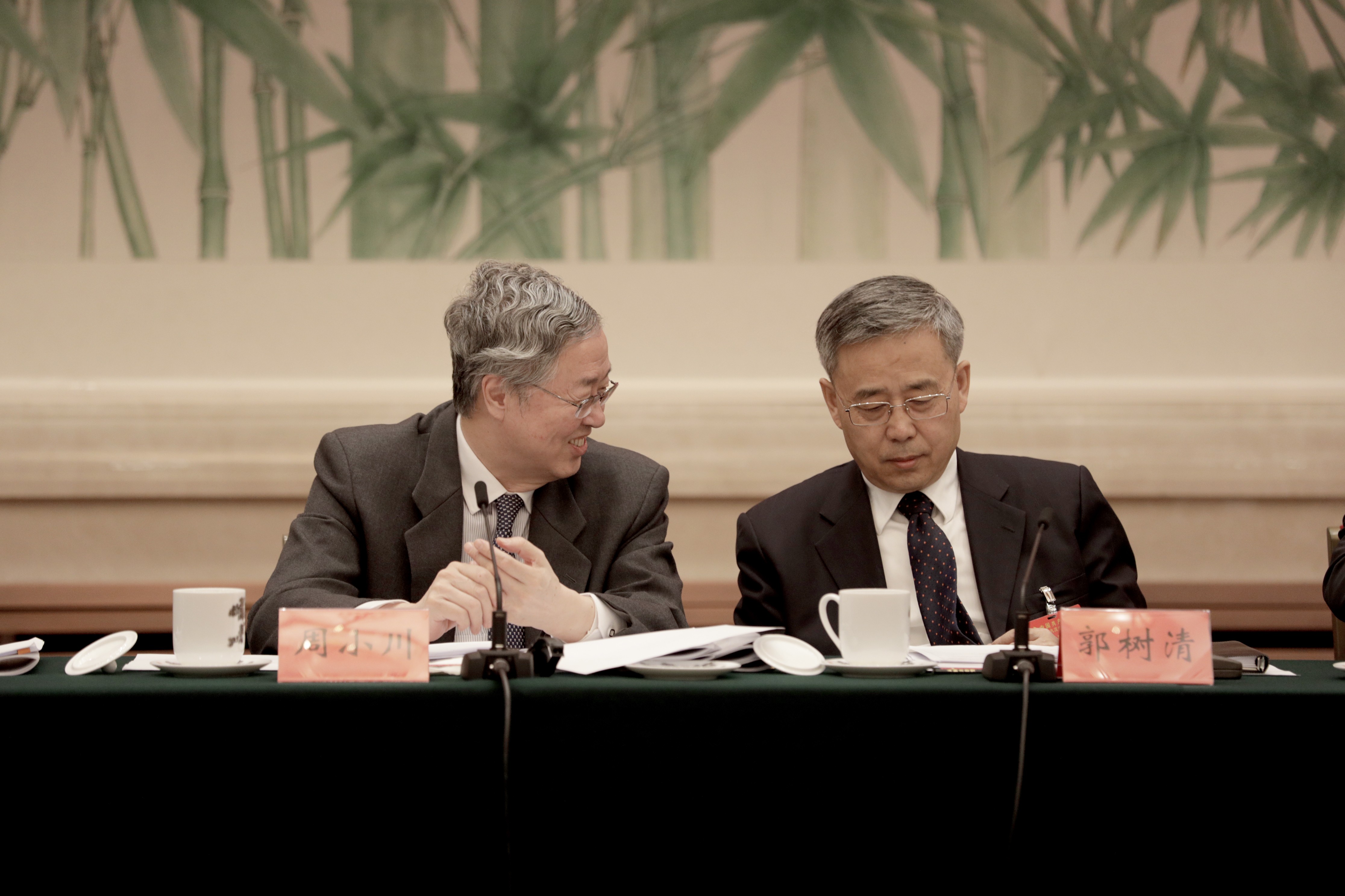 Zhou Xiaochuan, left, governor of the People's Bank of China (PBOC), left, pictured with Guo Shuqing this week at the Communist Party conference in Beijing. Photo: Bloomberg