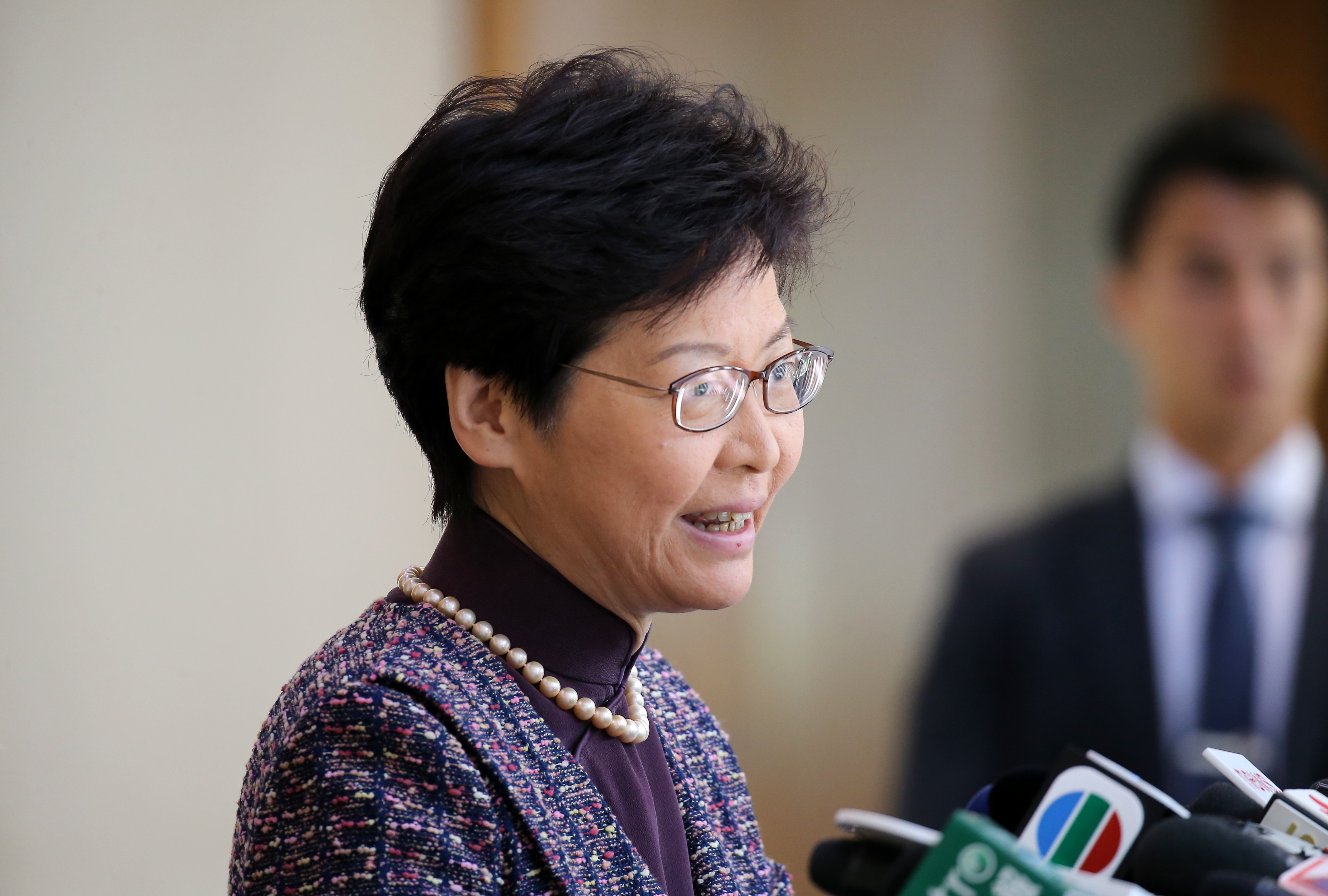Hong Kong’s leader says arrangement for declaration of employment does not carry any penalties, but has worked well for 10 years