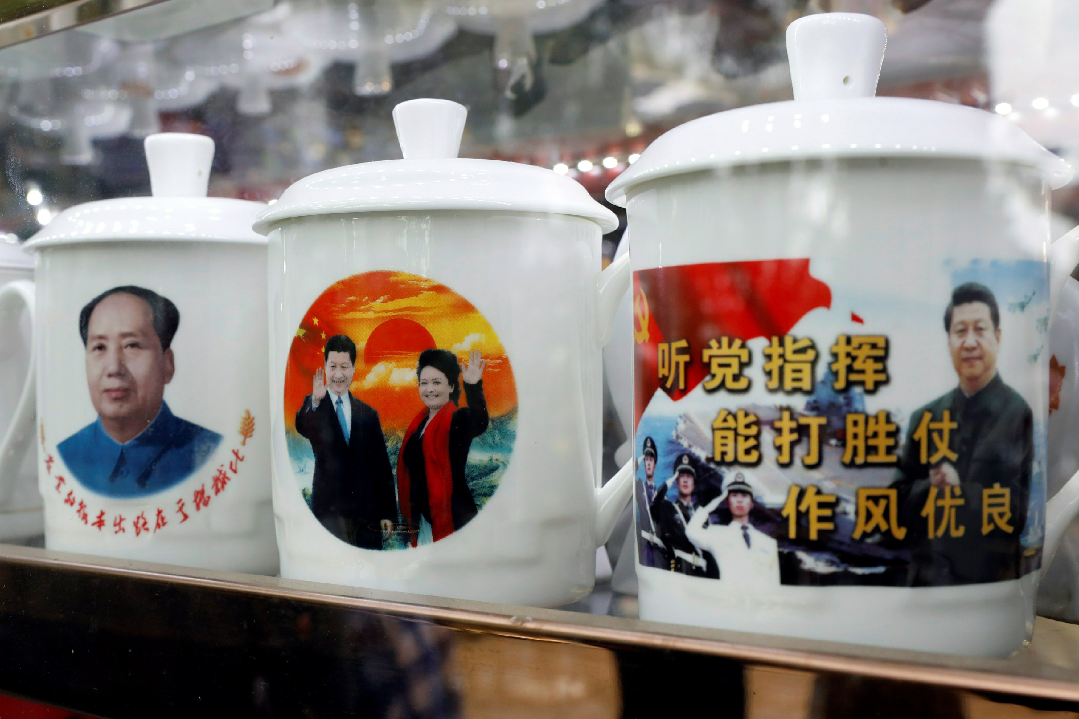 Souvenir cups with images of Mao Zedong and Xi Jinping on sale at a shop in Beijing. Photo: AP