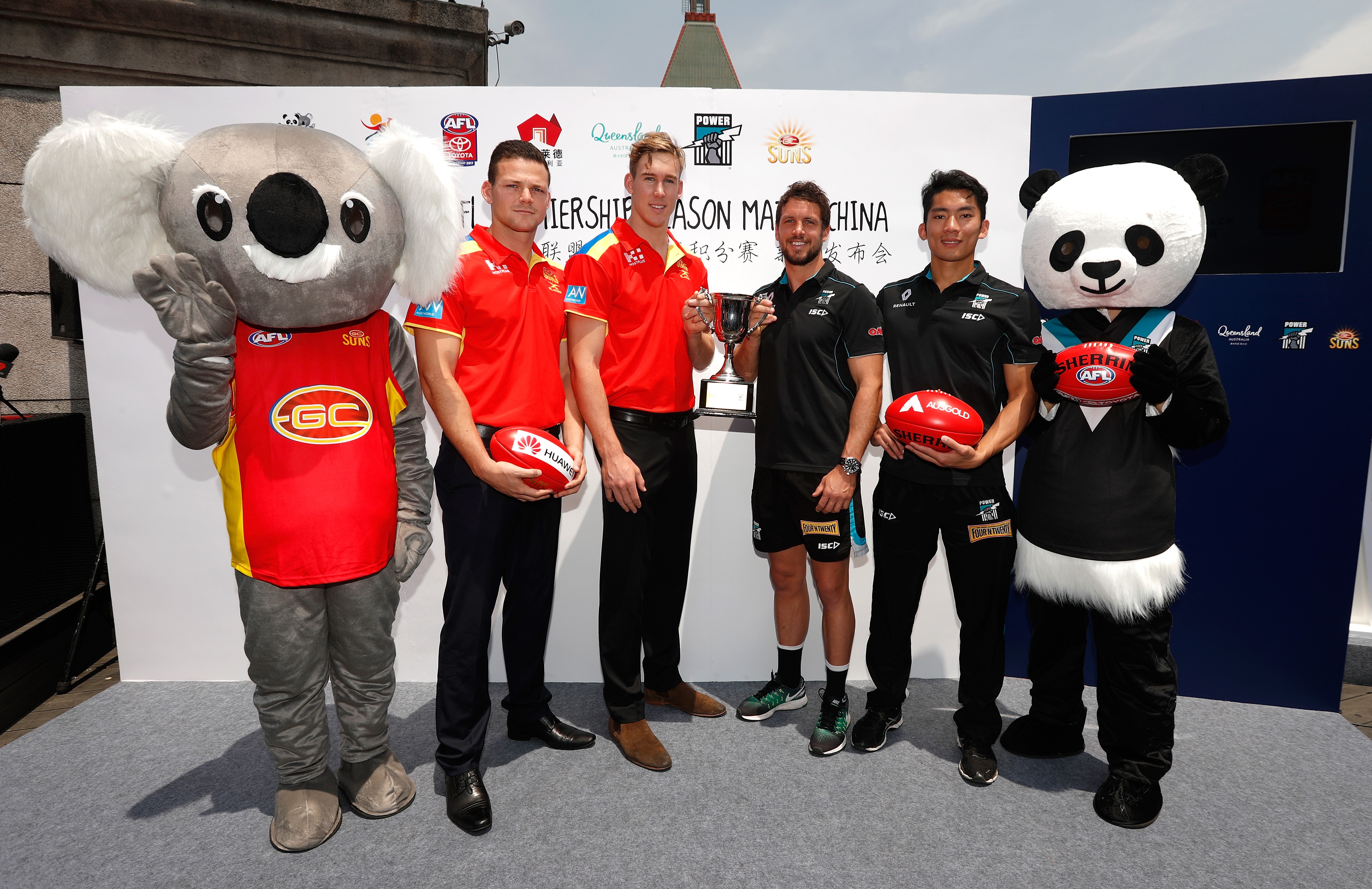 Steven May and Tom Lynch of the Suns (left) pose with Travis Boak and Chen Shaoliang of the Power during a press conference ahead of their first Australian Rules game in Shanghai earlier this year. Photo: Michael Willson / AFL Media