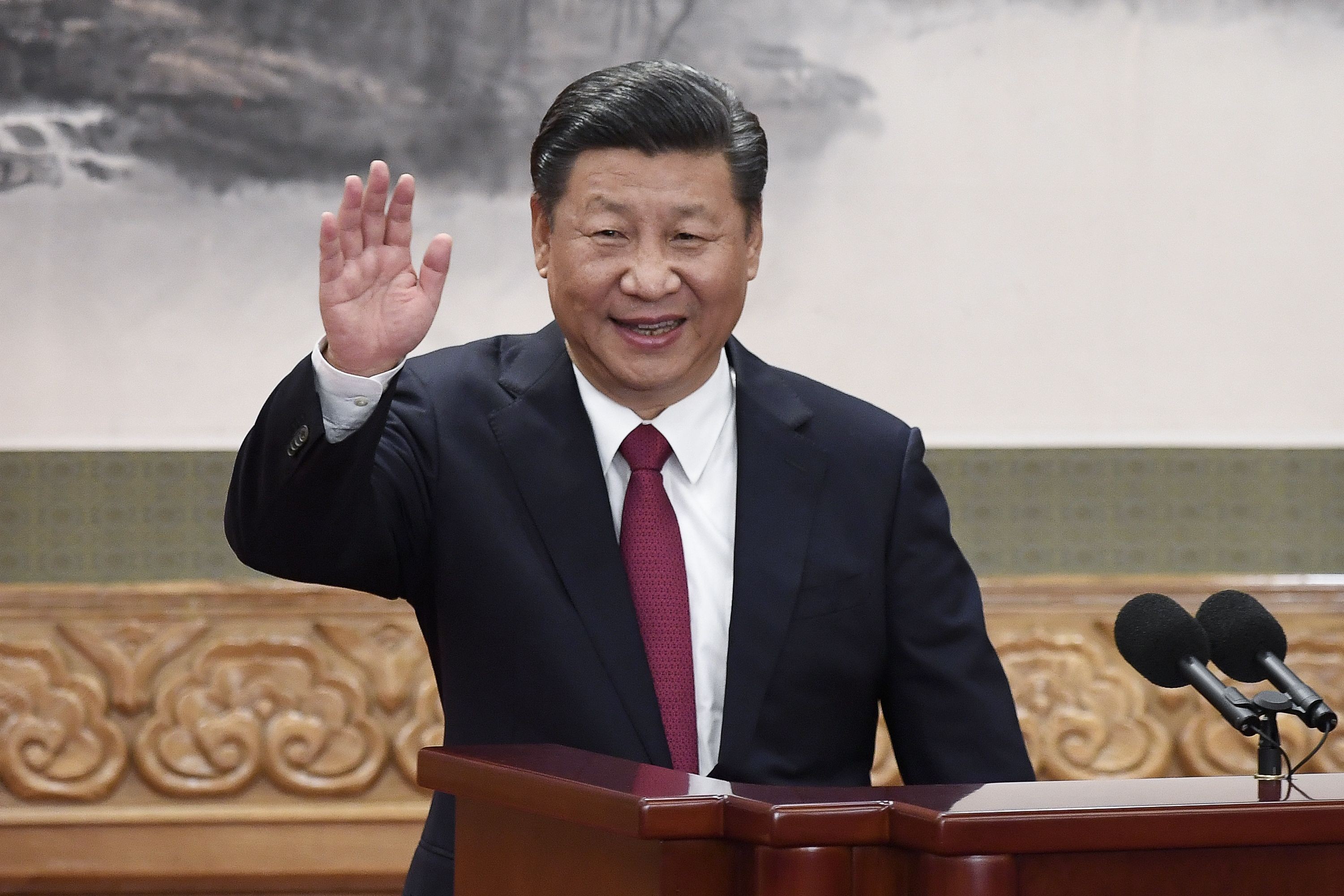 President Xi Jinping waves during the introduction of the new Politburo Standing Committee in Beijing. Photo: AFP