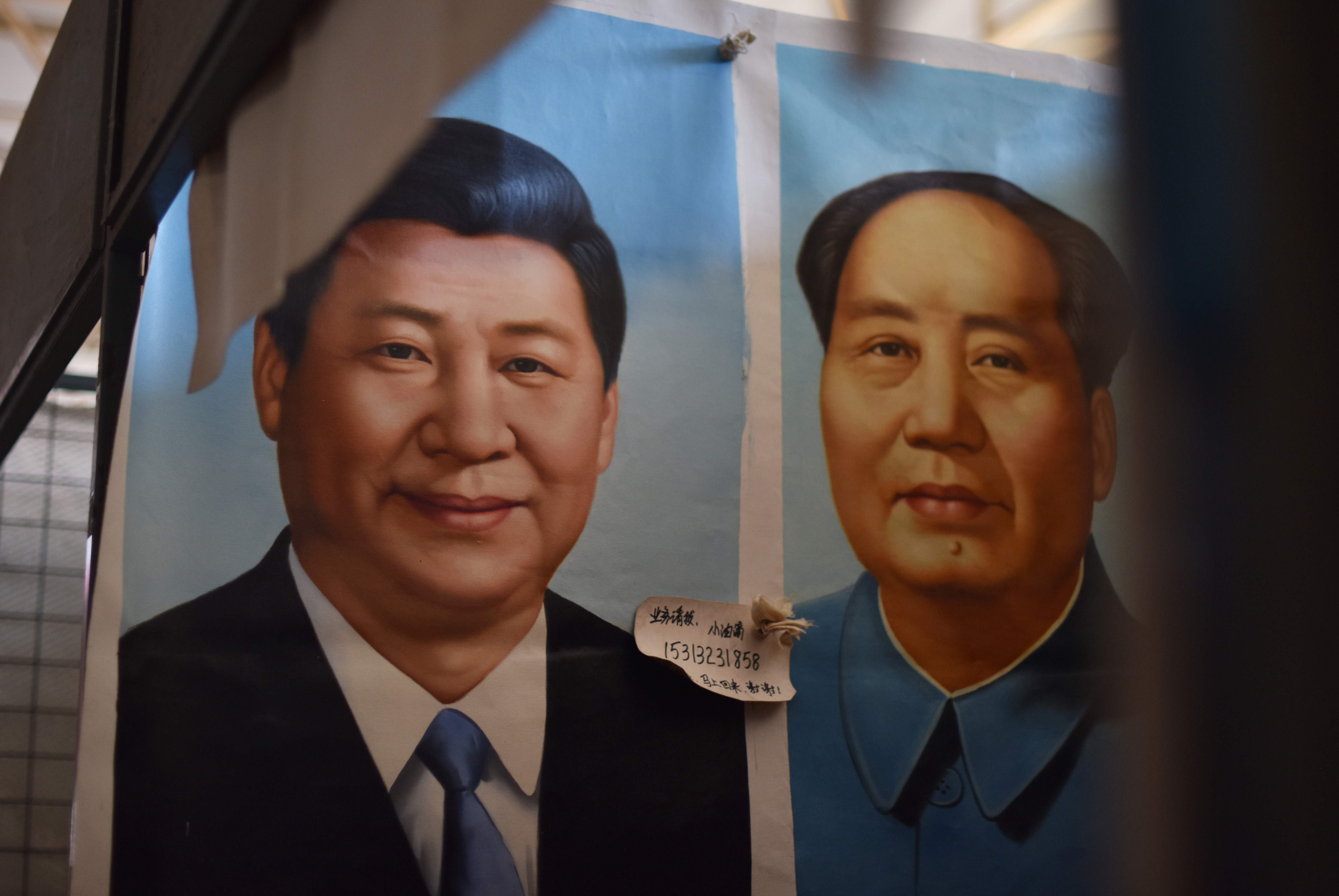 Portraits of Chinese President Xi Jinping (L) and late communist leader Mao Zedong at a market in Beijing. Xi’s decision not to elevate a designated successor at the party’s latest congress breaks with a 25-year tradition. Photo: AFP