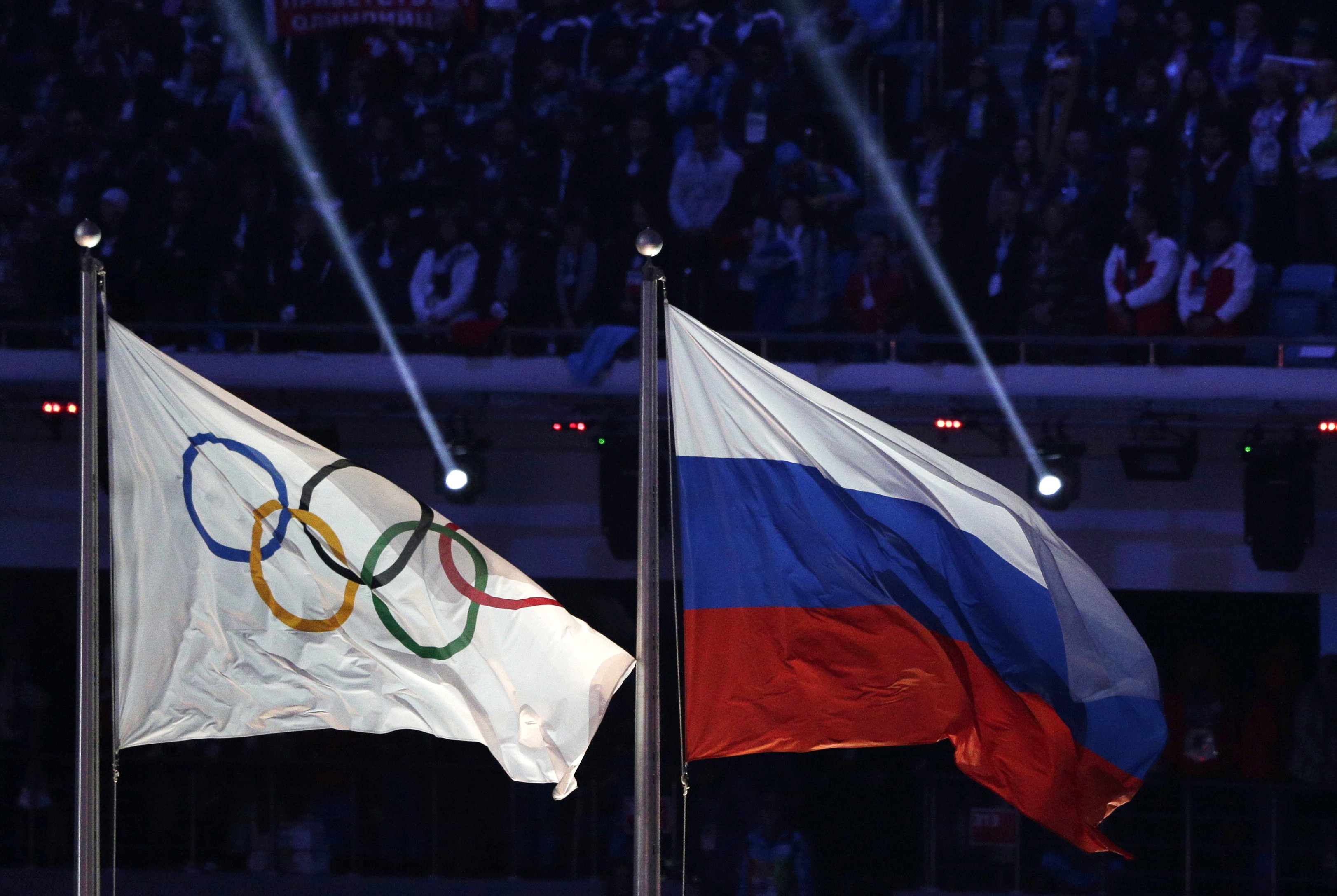 The Russian national flag flies after it is hoisted next to the Olympic flag during the closing ceremony of the 2014 Winter Olympics in Sochi, Russia. The World Anti-Doping Agency said it has a database proving widespread Russian doping. Photo: AP