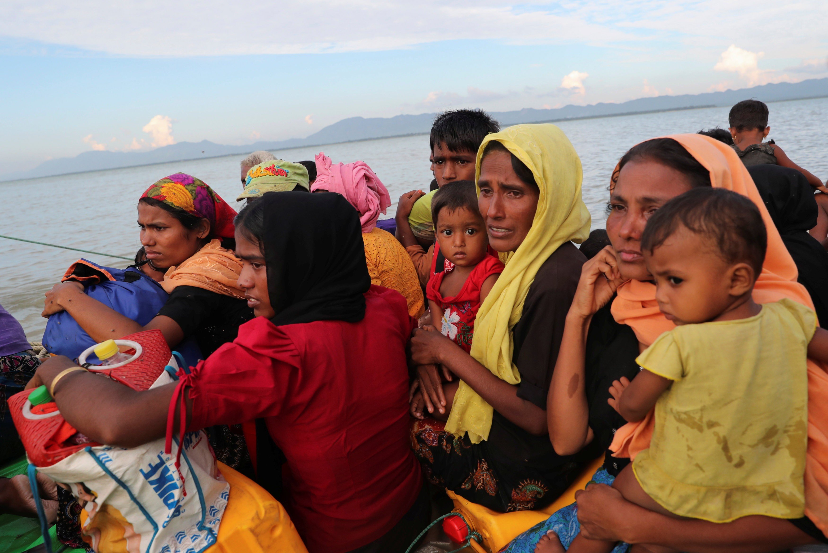 Rohingya refugees cross the Naf River with an improvised raft to reach Bangladesh on November 12. Photo: Reuters