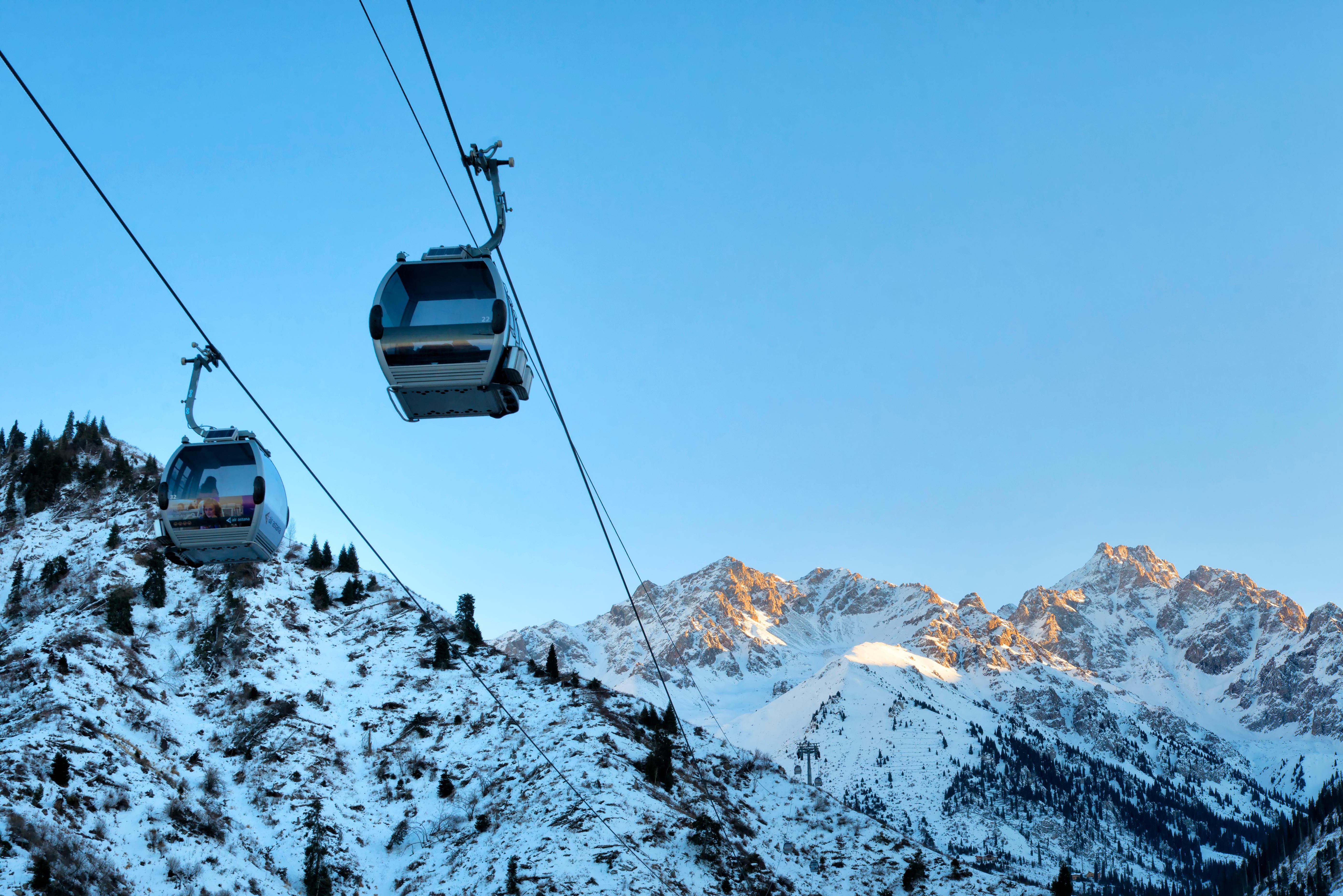 Cable cars going to and from the Shymbulak Ski Resort, one of the best places to ski in Kazakhstan. Photo: Alamy