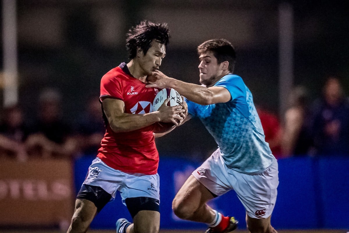 Hong Kong’s Salom Yiu Kam-shing attempts to shrug a tackle against Russia. Photo: HKRU