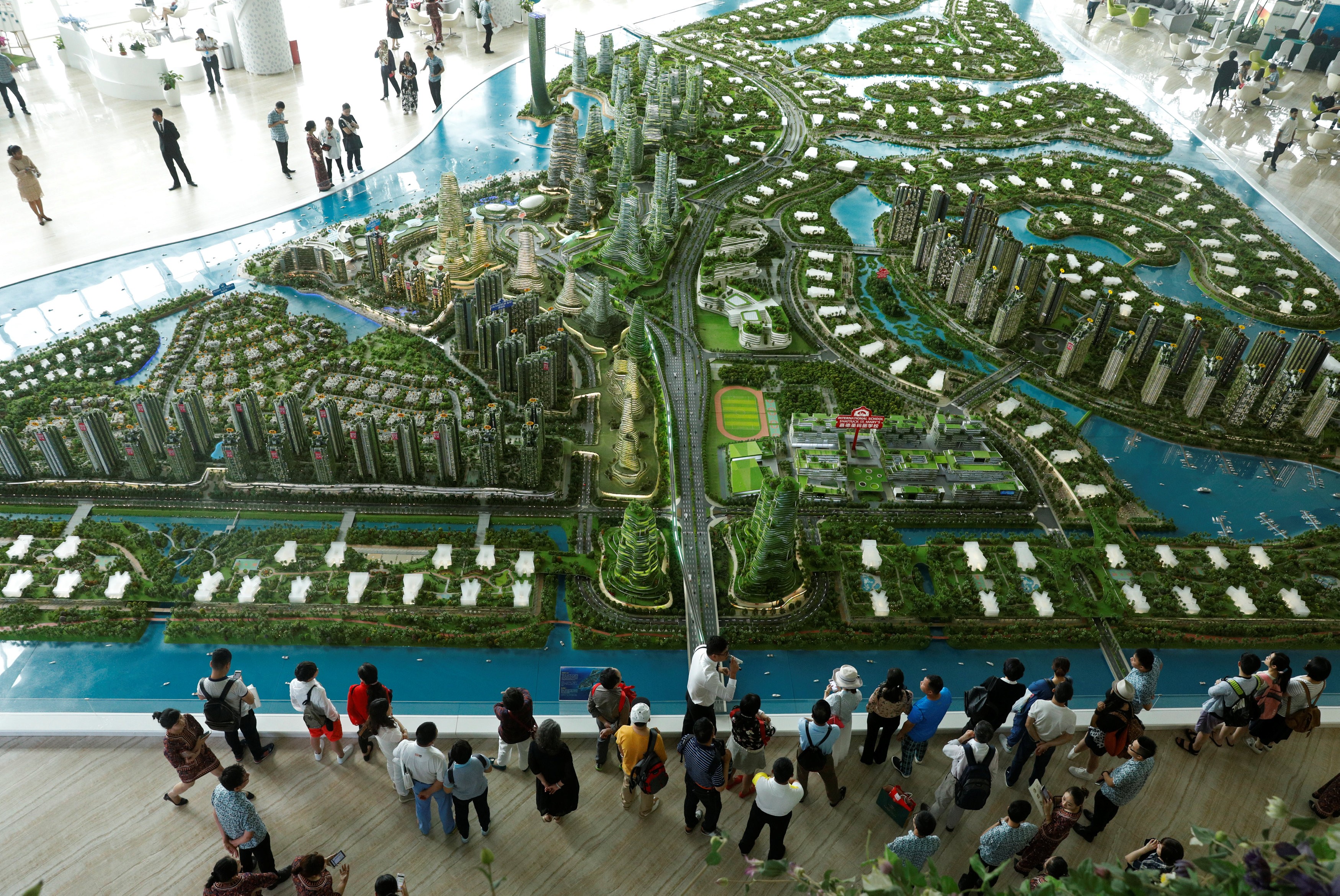 Prospective buyers look at a model of the development at the Country Gardens' Forest City showroom in Johor Baharu, Malaysia in February. Photo: Reuters