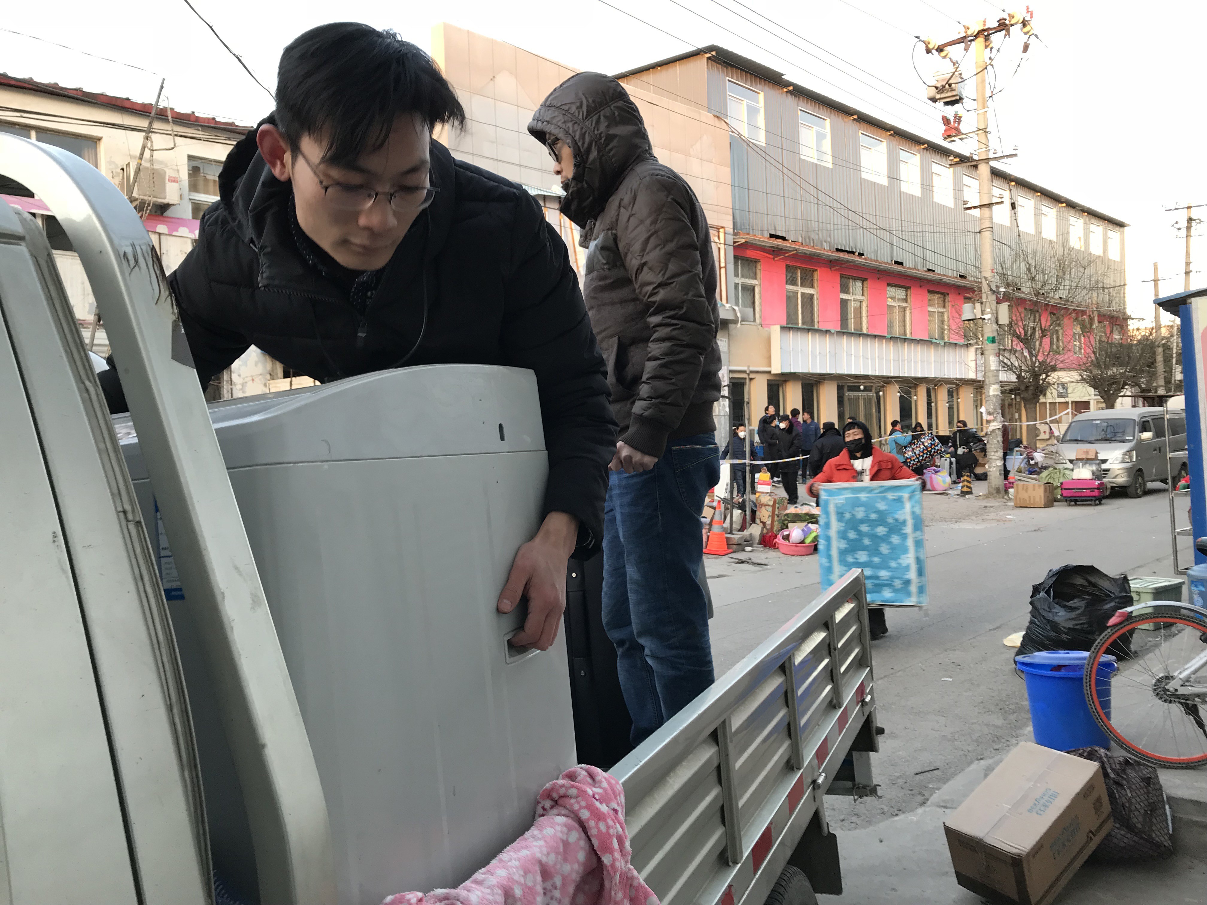 People move out of a residential building on the outskirts of Beijing close to where a fire in a two-storey structure killed 19 people this month. Photo: Simon Song