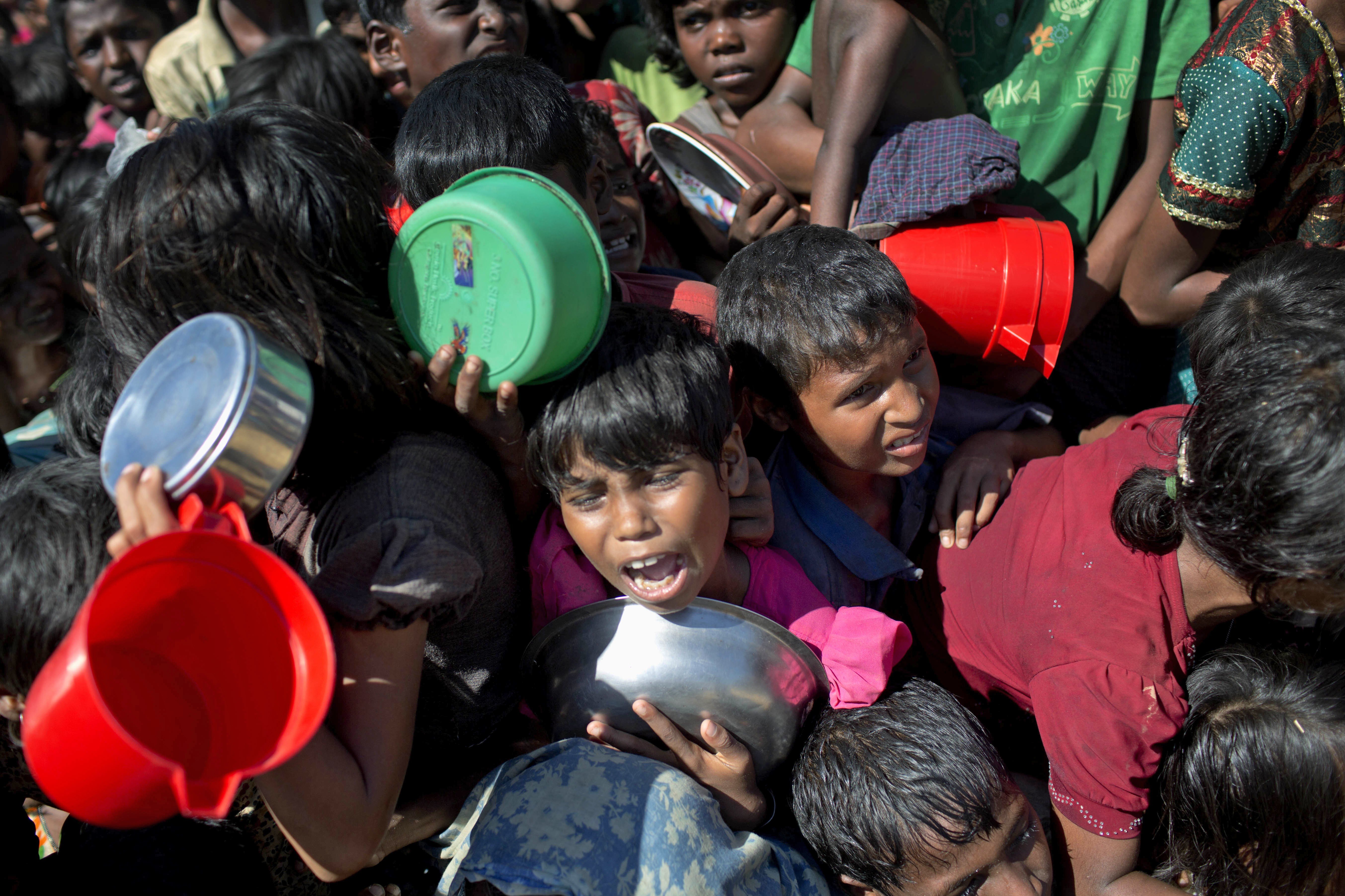 A Rohingya Muslim cries out in the crush of women and children waiting to receive food handouts from a Turkish aid agency at Thaingkhali refugee camp in Ukhiya, Bangladesh, on November 14. Photo: AP