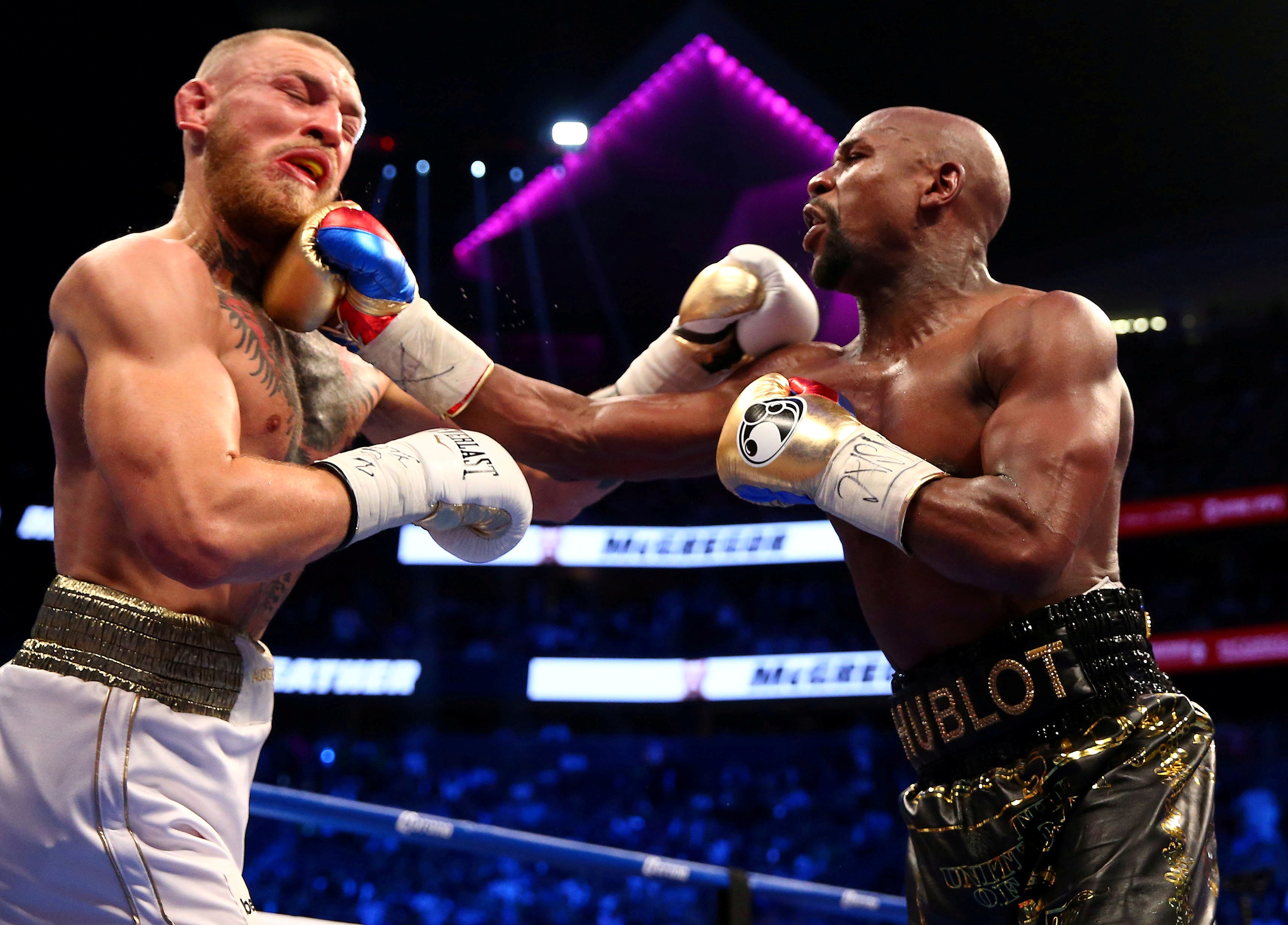 Floyd Mayweather Jnr (right) on his way to victory against Conor McGregor in their fight in Las Vegas in August. Photo: USA Today