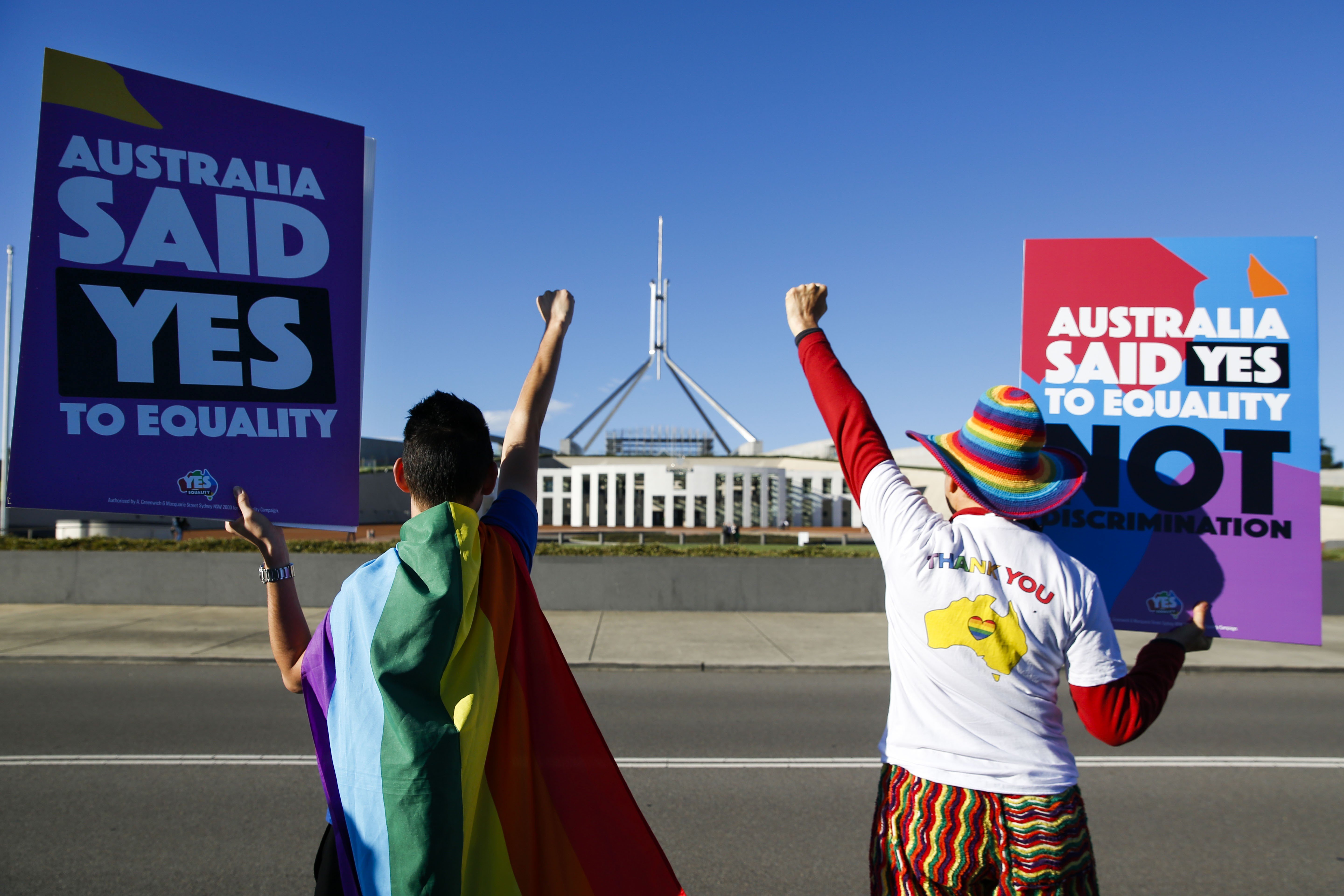 Equality ambassadors and volunteers from the Equality Campaign celebrate in front of Parliament House in Canberra ahead of the parliamentary vote on same sex marriage, which was passed. Photo: AFP