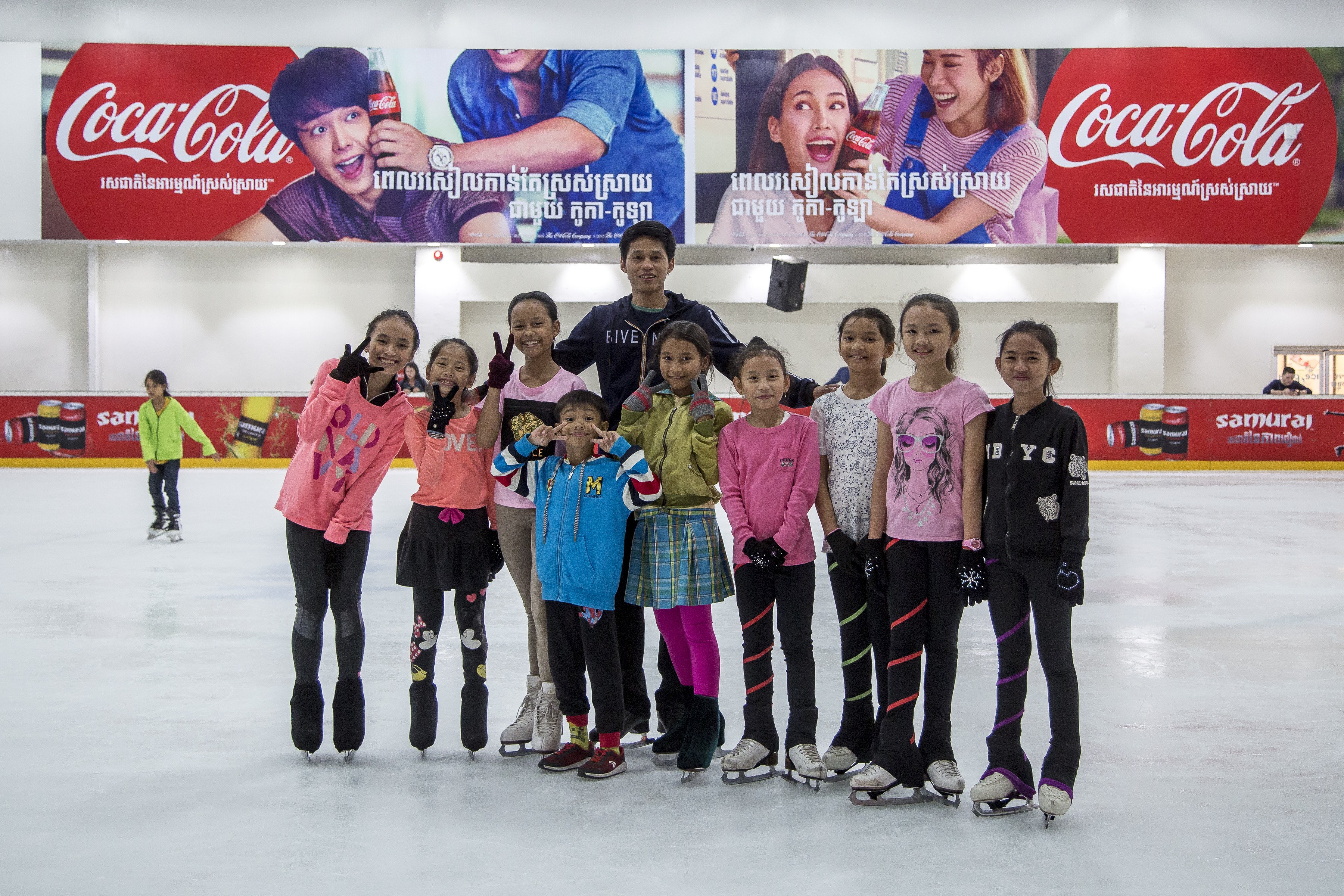 Sen Bunthoeurn, who competed at the Southeast Asian Games, with some of the young skaters he coaches in Phnom Penh.