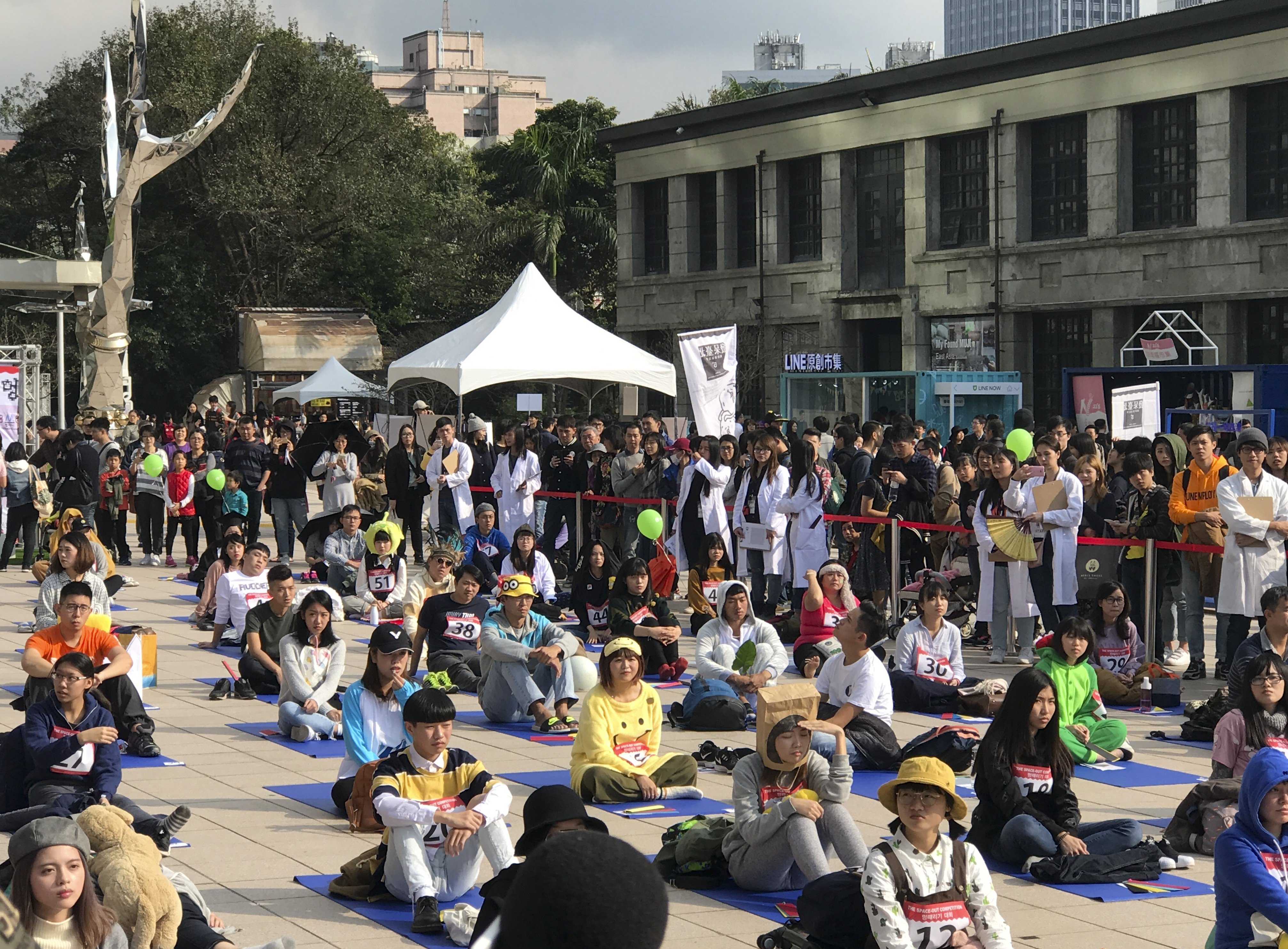 Contestants do their best at doing nothing in Songshan Cultural Creative Park in central Taipei on Sunday. Photo: Louise Watt