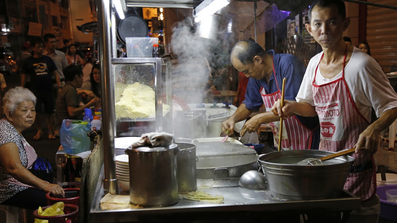 A cook prepares a noodle dish from a street food stall along Lebuh Chulia, a popular nightlife strip, in George Town on the island of Penang, Malaysia. Photo: AP Photo/Adam Schreck