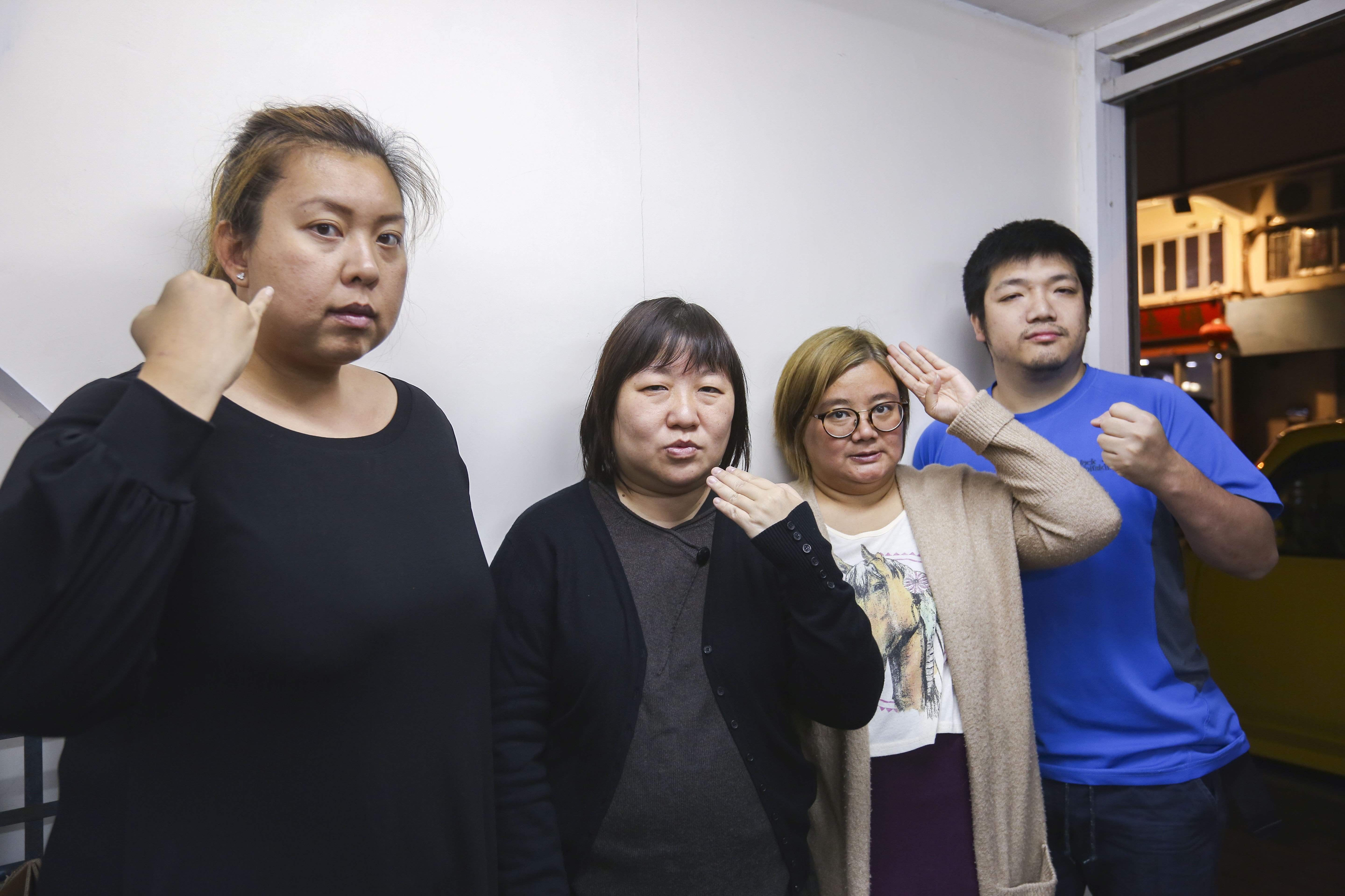 From left: Christine Chu Chi-yan, Joyce Pun Chung-see, Connie Lo Chun-you and Kane Cheung Chung-kit make a sign which means ‘deaf people’s right to call the police’. Photo: Xiaomei Chen