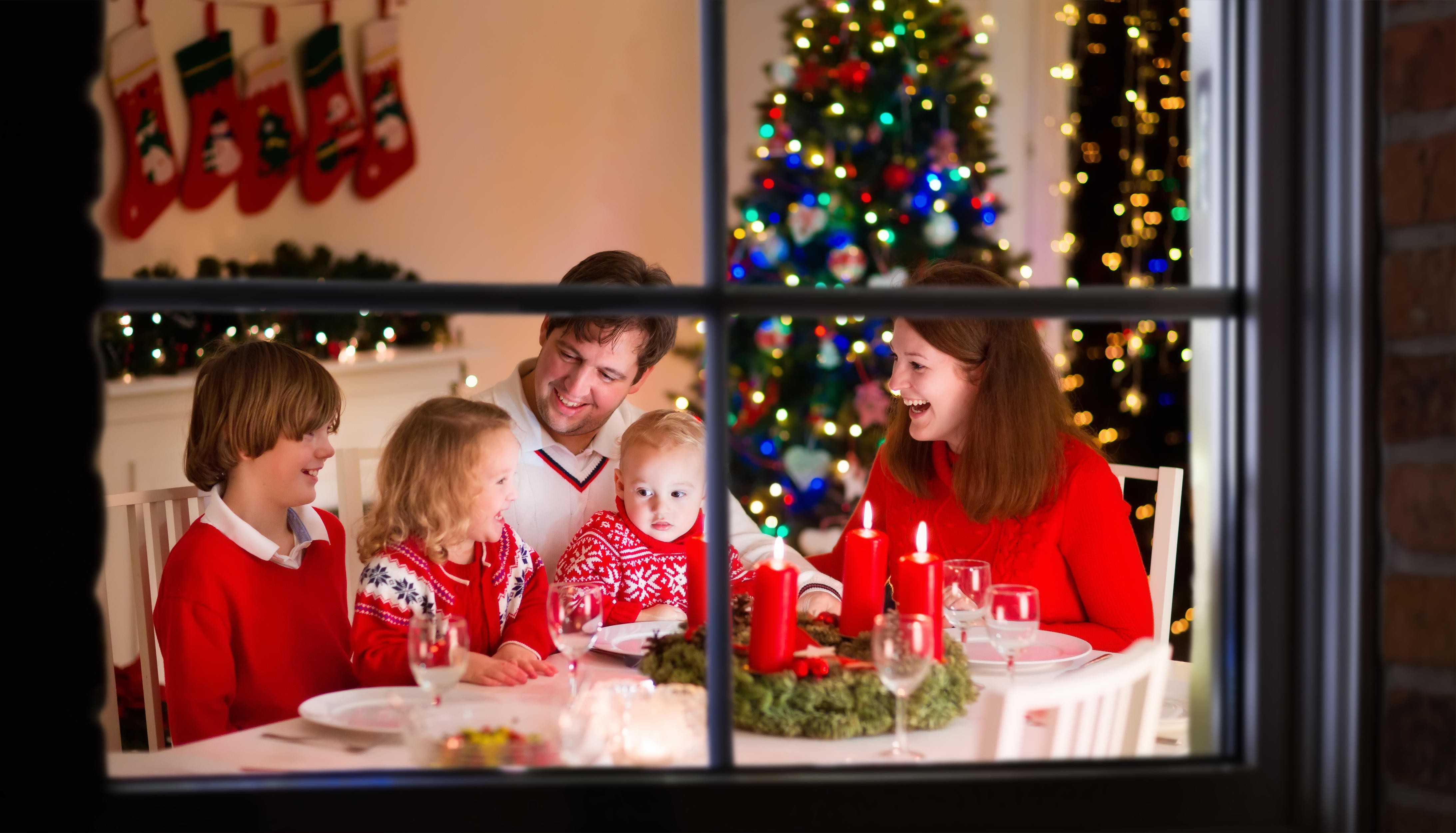 Stock photo of a family with three children celebrating Christmas at home. Photo: Alamy