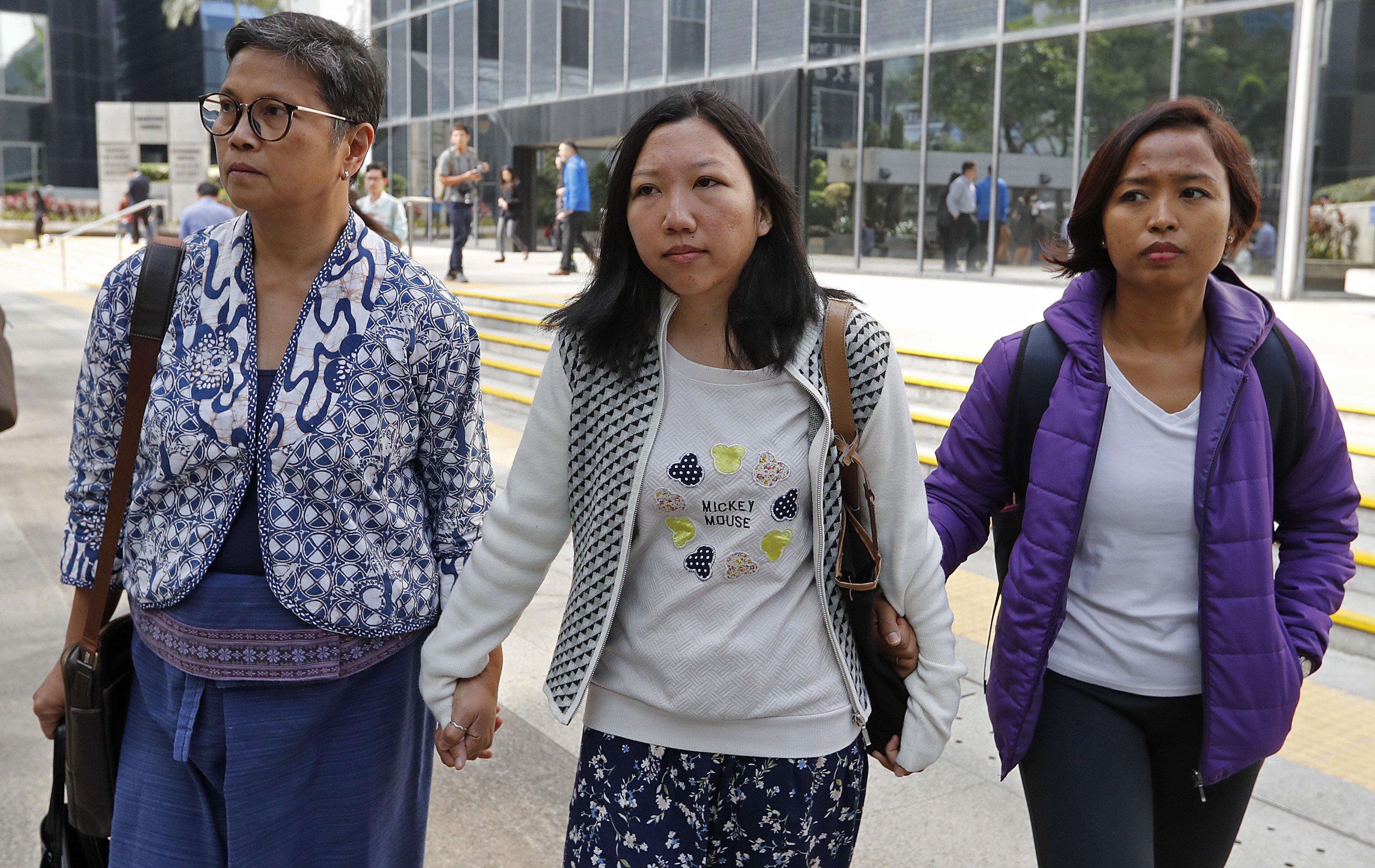 Former domestic helper Erwiana Sulistyaningsih (centre) successfully won her claim against her abusive former employer. Photo: Edward Wong