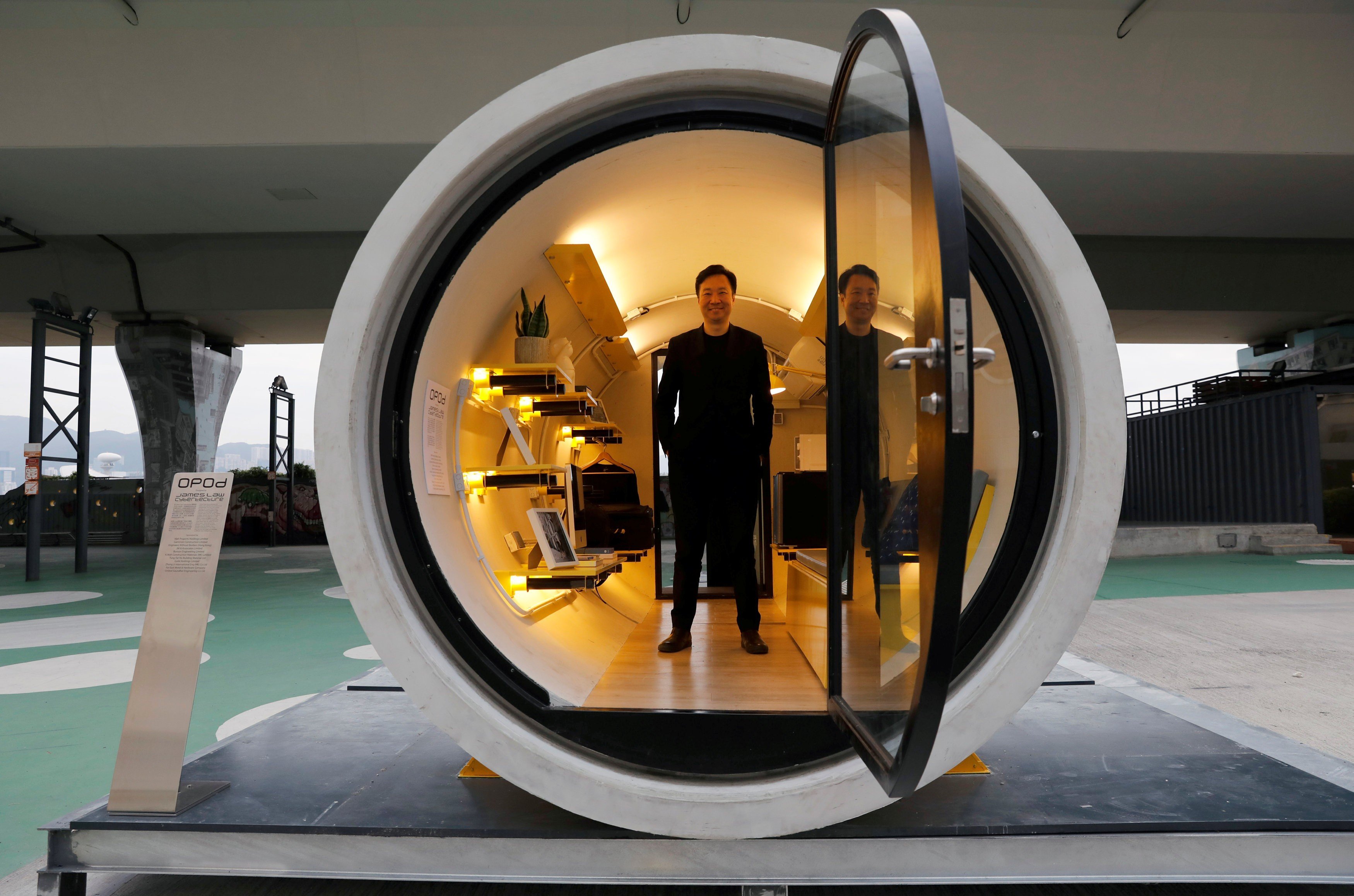 Architect James Law poses earlier this month inside his work, the "Opod" – a 120-square foot giant water pipe, designed as micro-housing in Hong Kong. Photo: Reuters