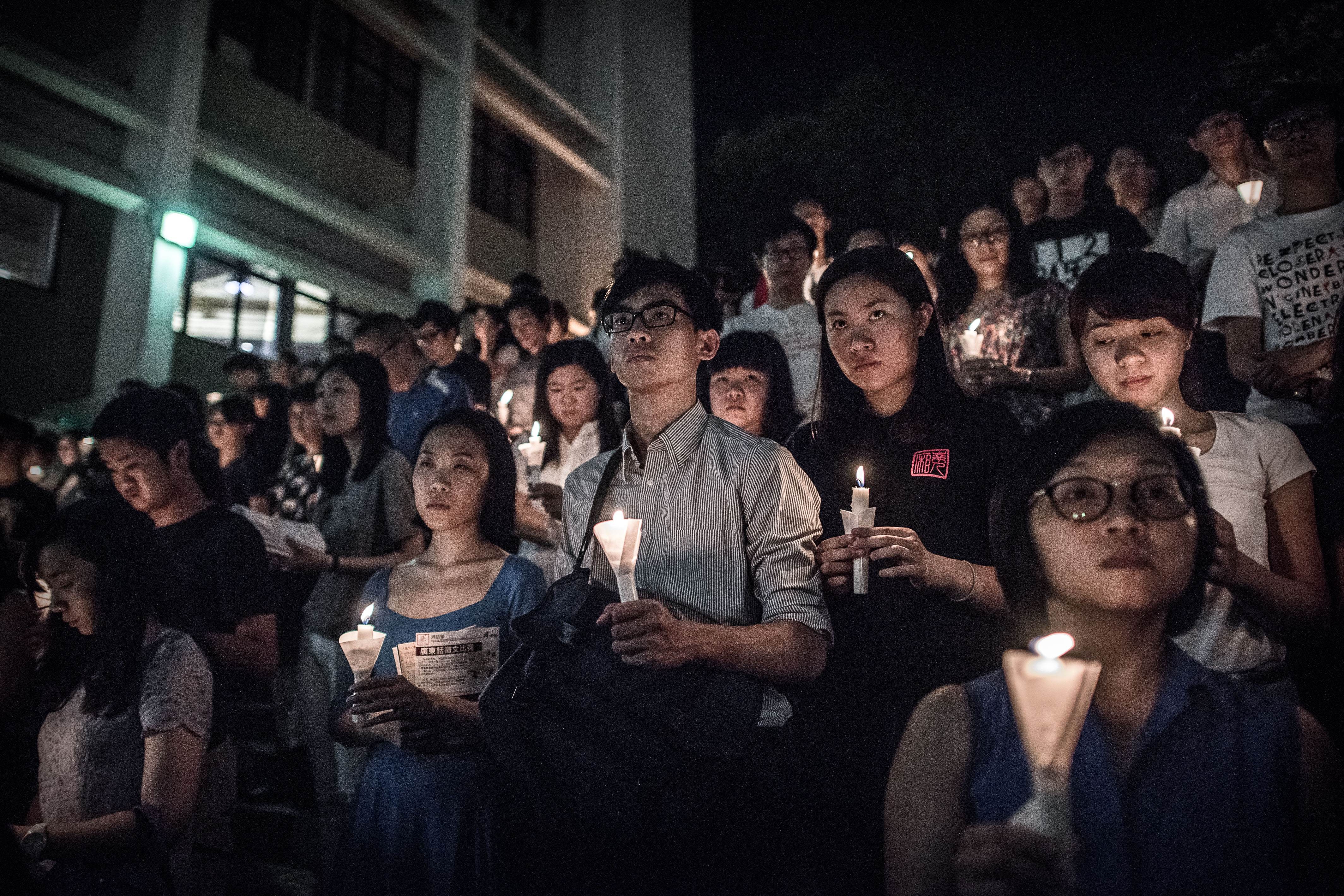 Participants hold candles during a vigil organised by students to commemorate the 1989 Tiananmen Square crackdown at the University of Hong Kong, in June 2015. Photo: AFP