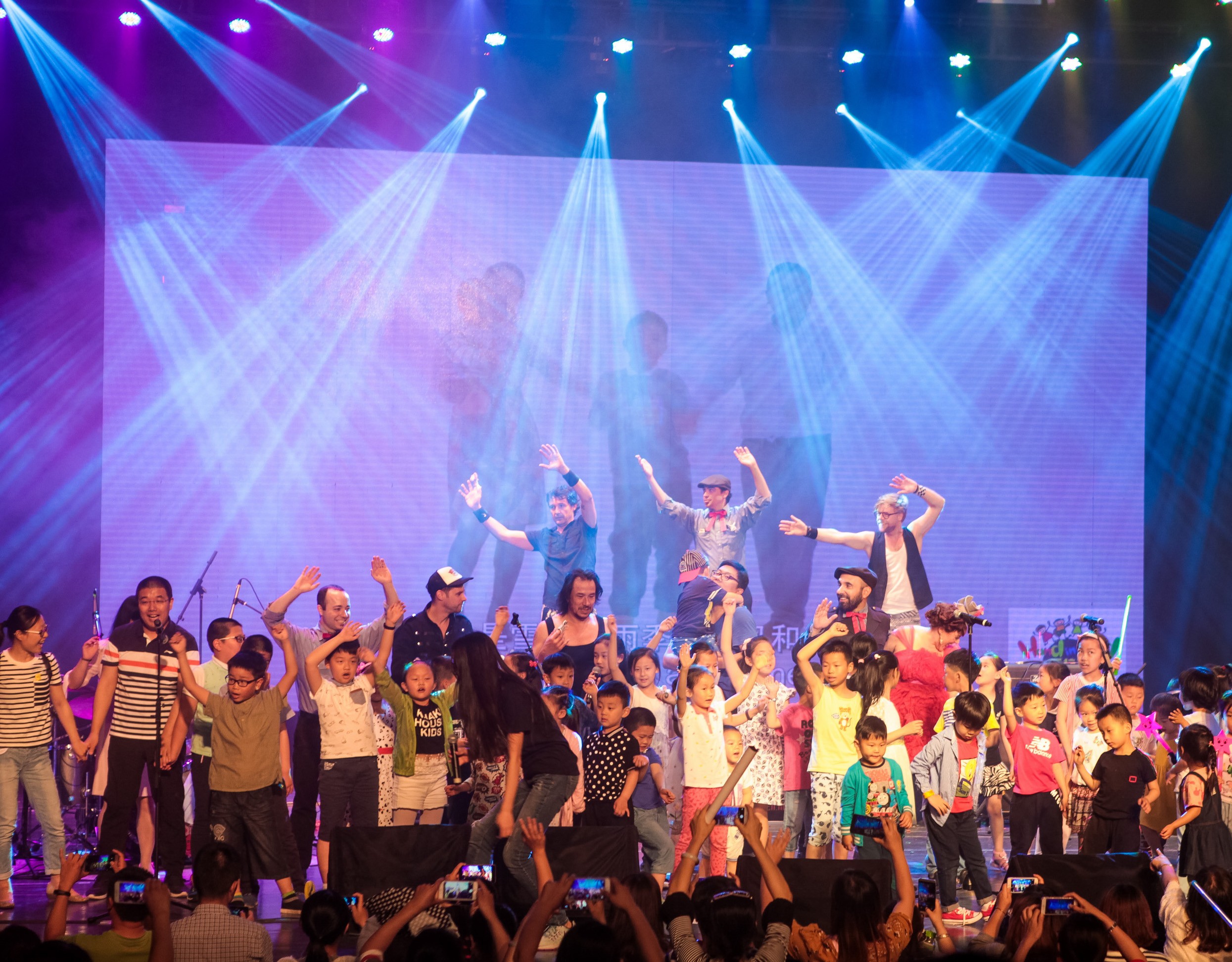 Children and parents taking the stage during a performance by Lucky Diaz and the Family Jam Band at the Hand in Hand Music Festival.